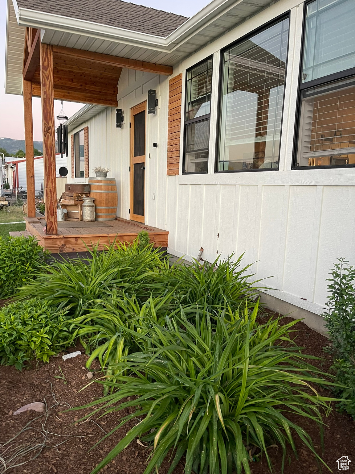 Entrance to property featuring a porch (Summertime)