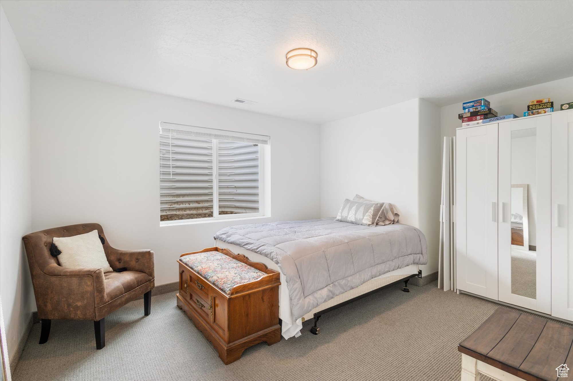 Bedroom with light colored carpet