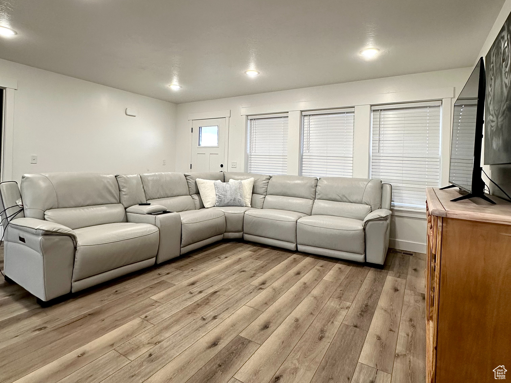 Living room with light hardwood / wood-style floors and a textured ceiling