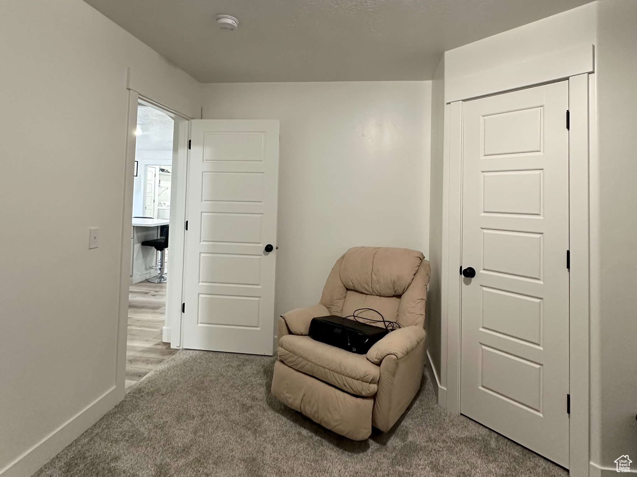Bedroom 1 featuring carpet and a textured ceiling