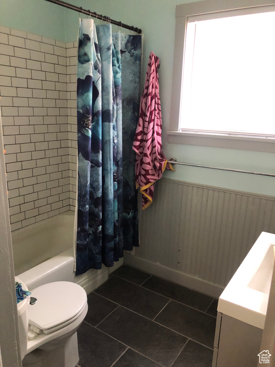 Full bathroom featuring vanity, tile patterned floors, toilet, and shower / bath combo with shower curtain