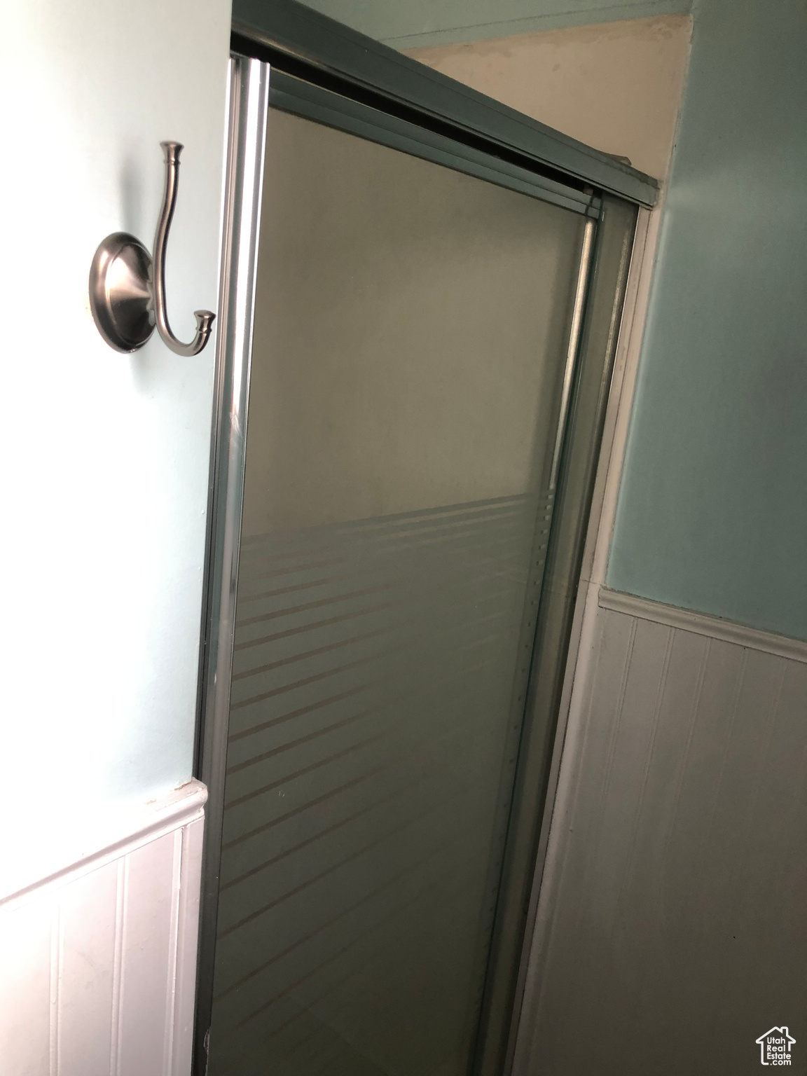 Bathroom featuring a shower with door