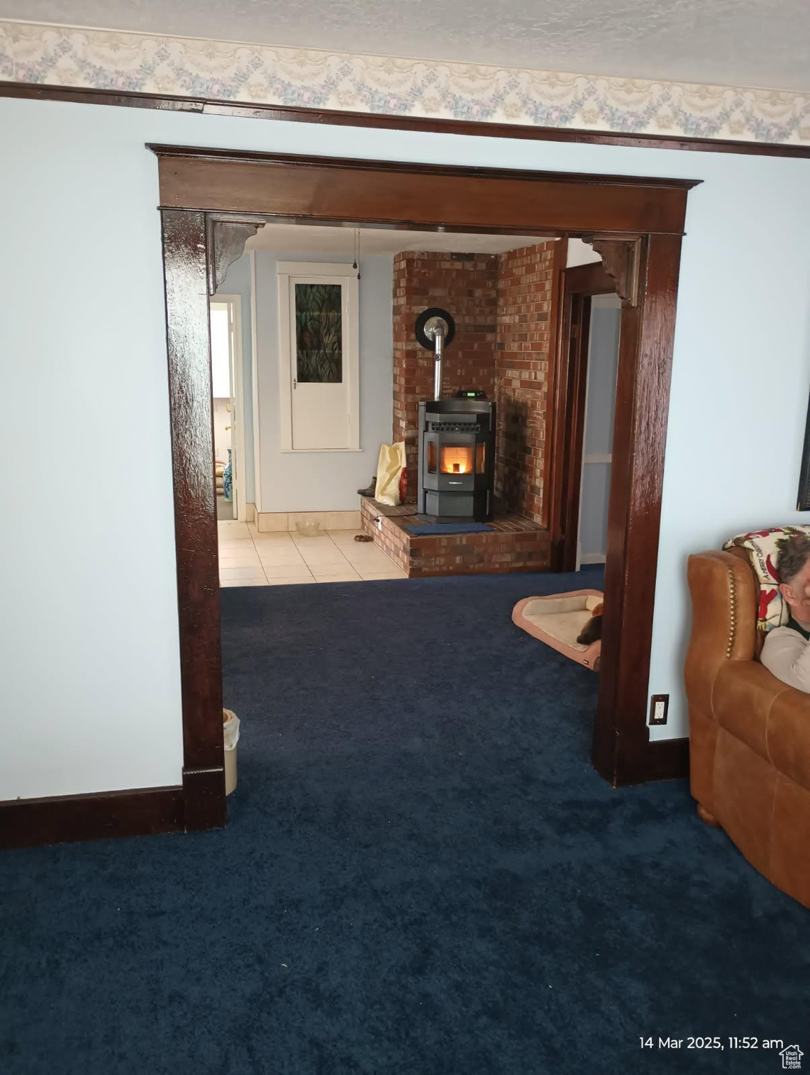 Corridor featuring tile patterned floors, baseboards, and carpet