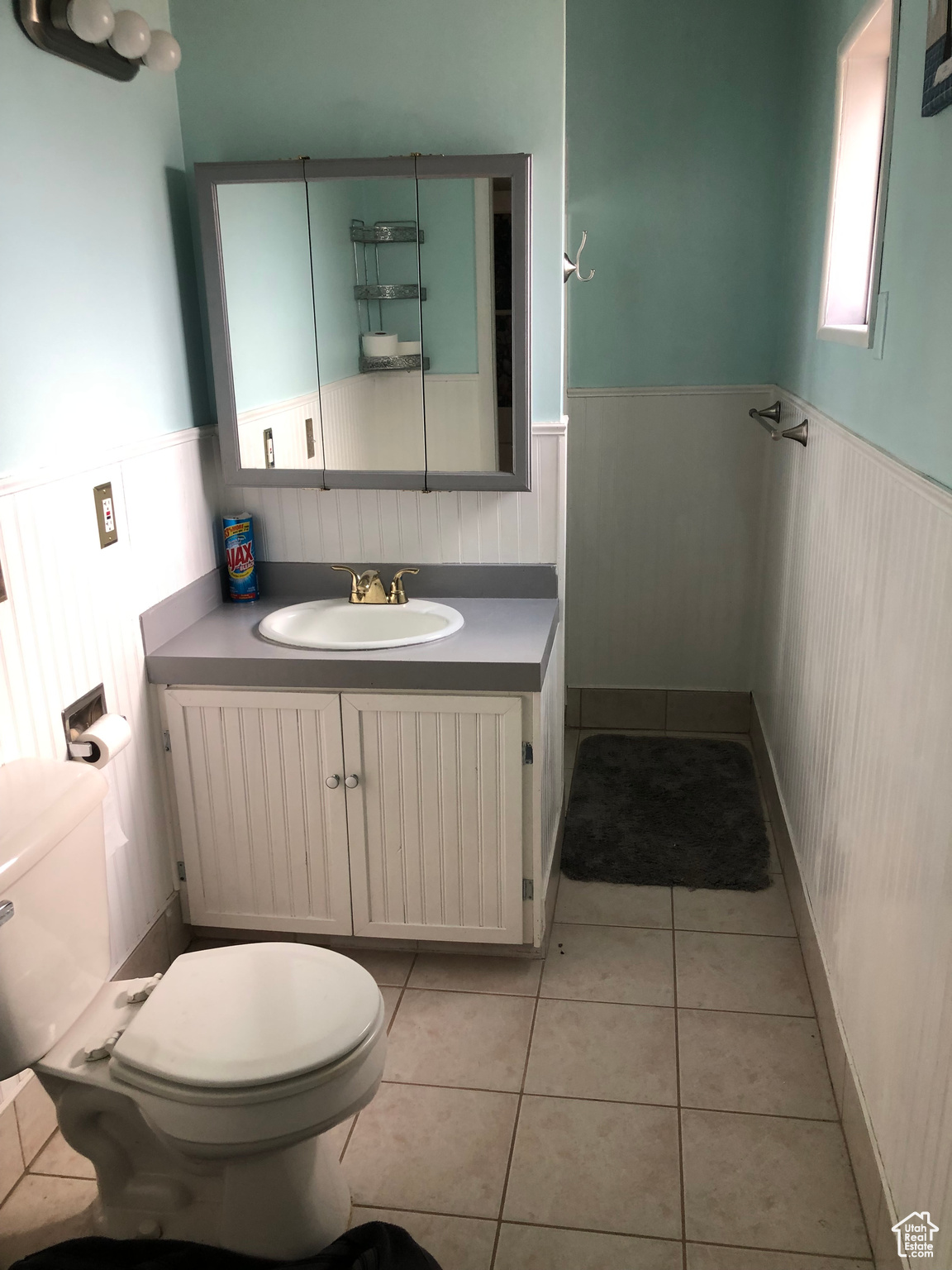 Bathroom featuring vanity, tile patterned floors, and toilet