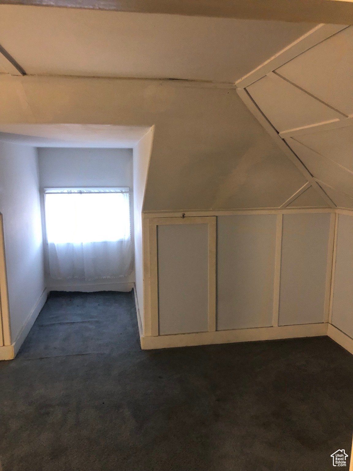 Additional living space with dark carpet