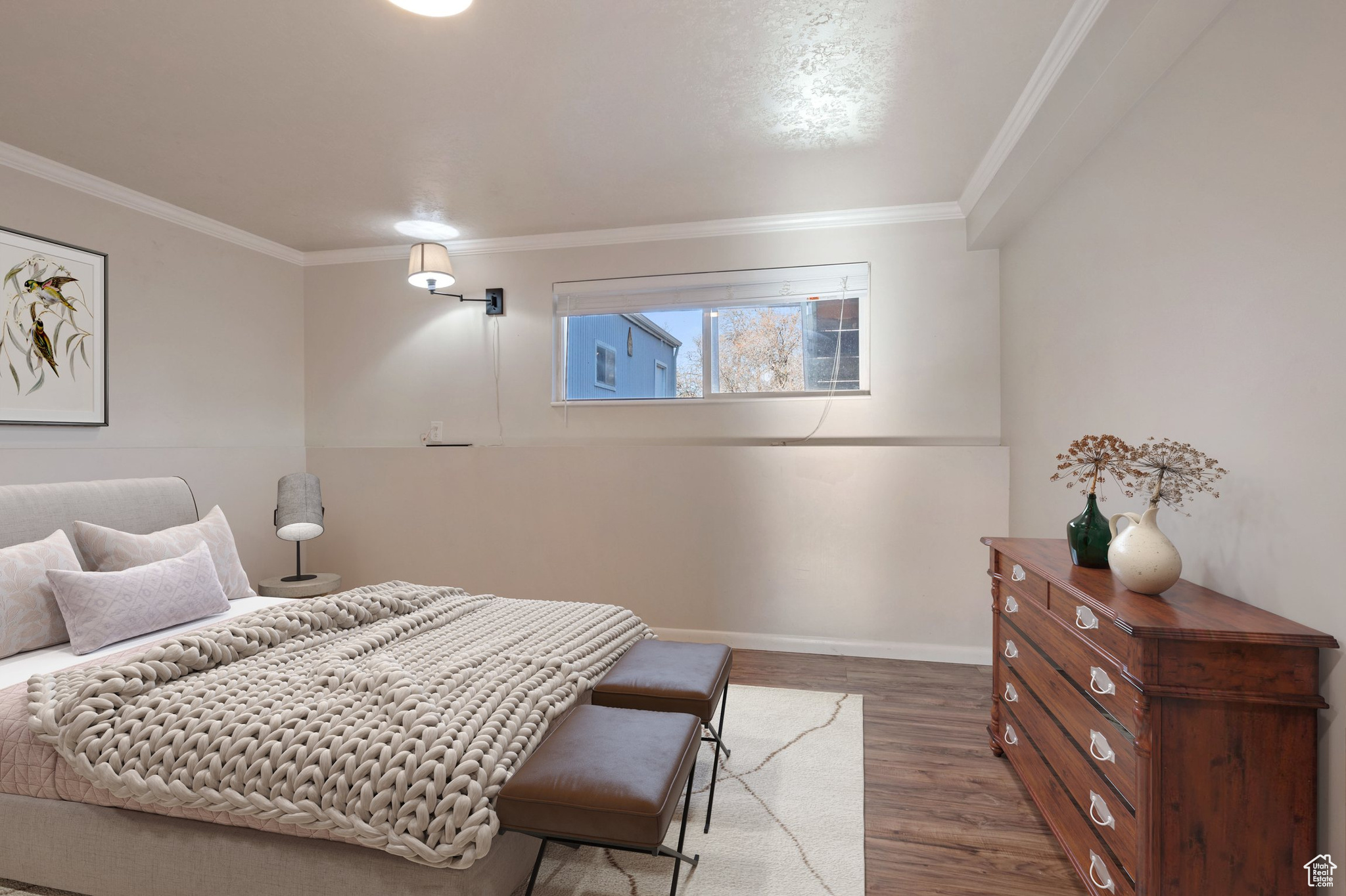 Bedroom featuring crown molding, baseboards, and wood finished floors
