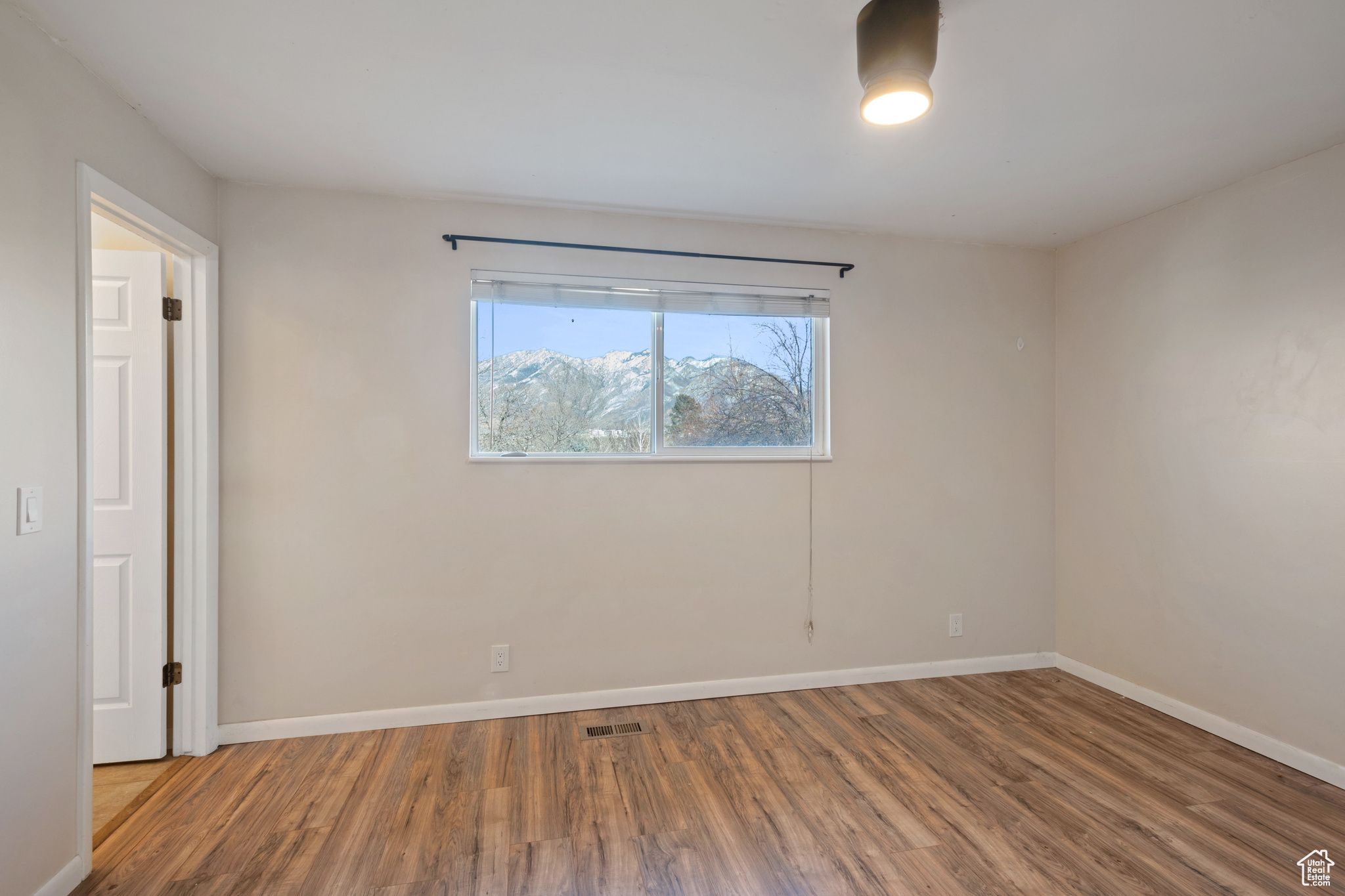 Unfurnished room featuring wood-type flooring