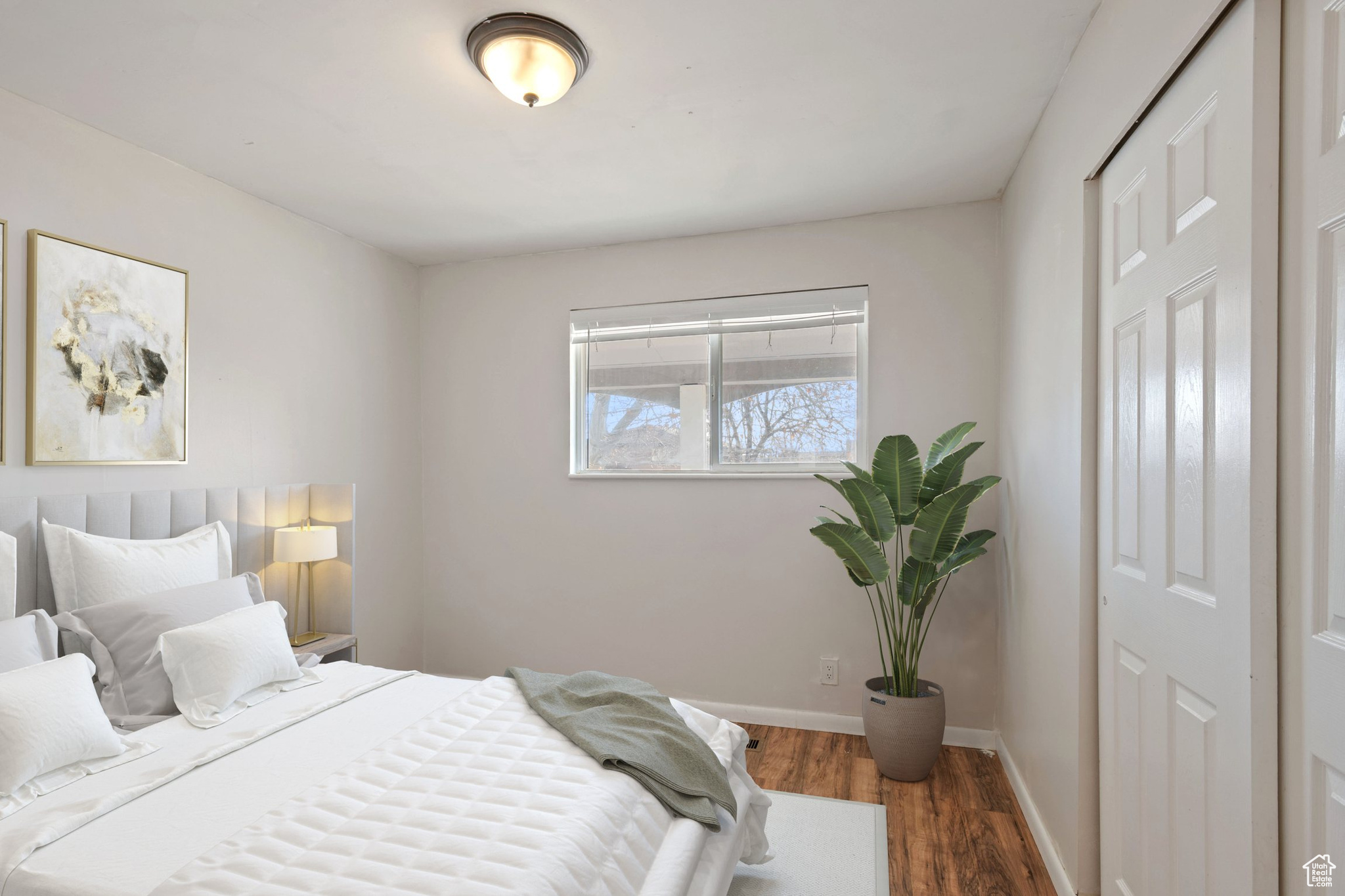 Bedroom featuring baseboards and wood finished floors