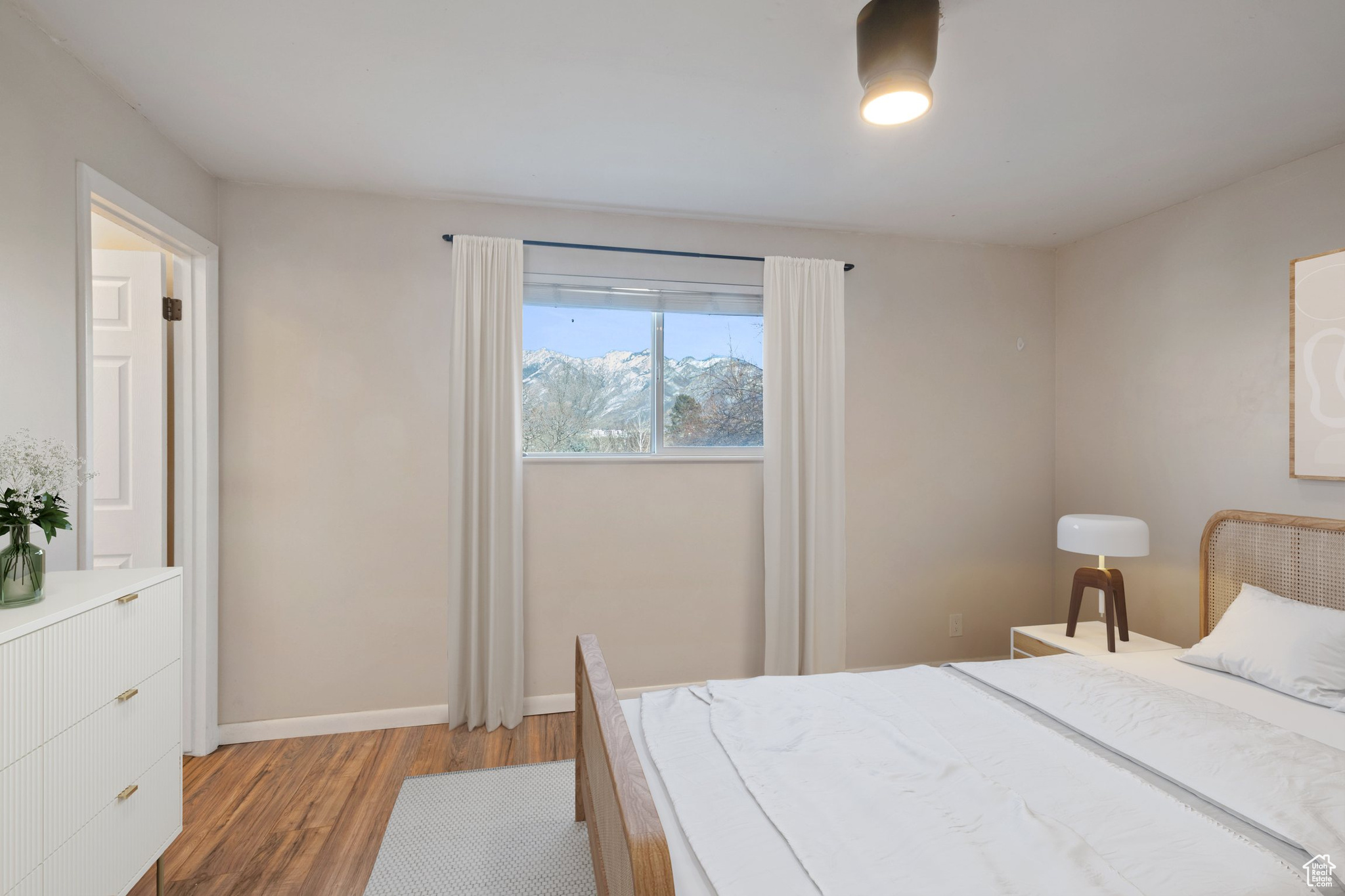 Bedroom featuring light wood finished floors and baseboards