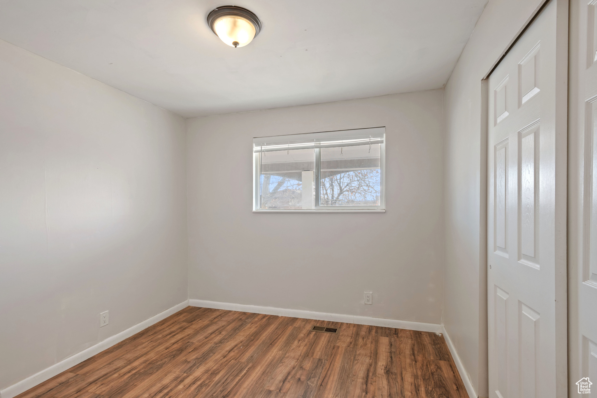 Unfurnished room featuring dark hardwood / wood-style flooring