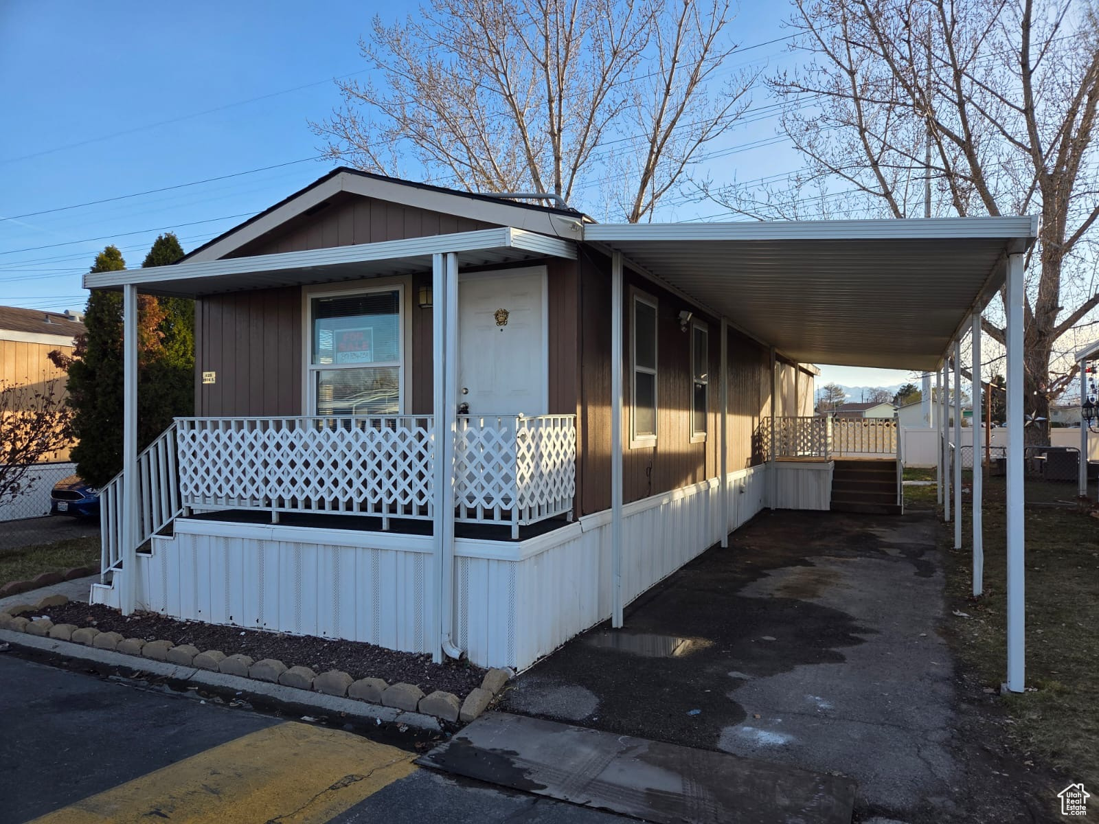 Manufactured / mobile home featuring a carport and a porch