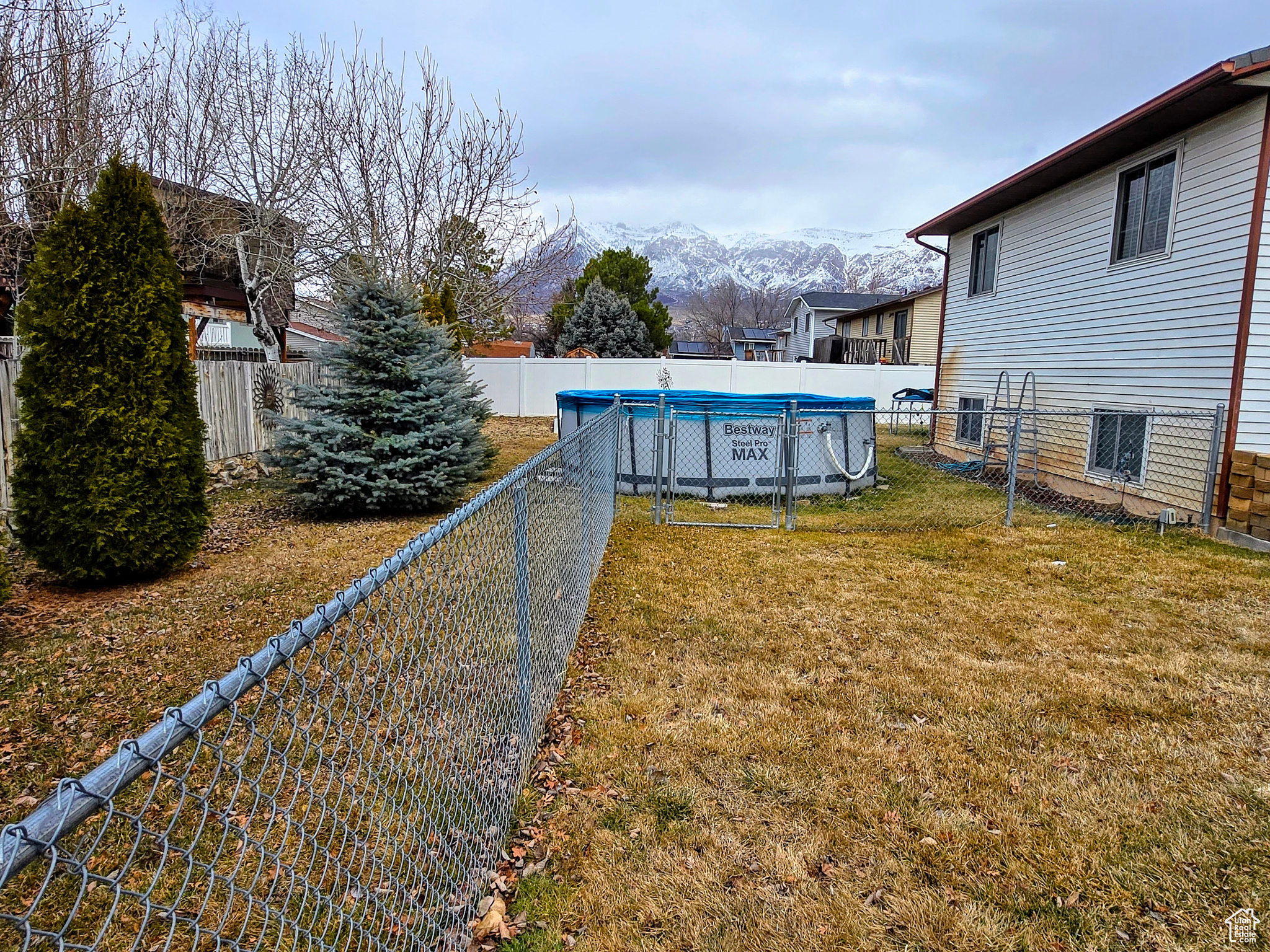 View of yard with a mountain view and a covered pool
