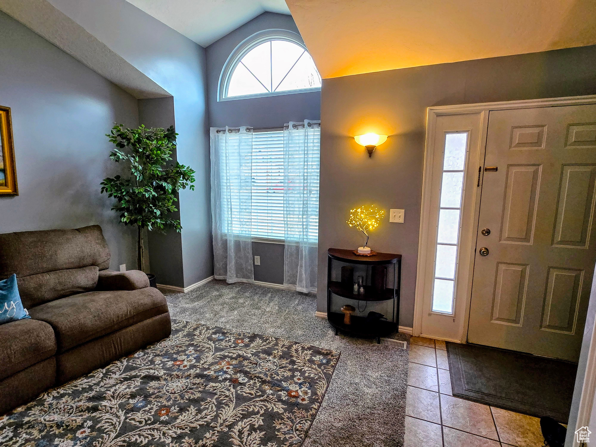 Tiled entryway with vaulted ceiling