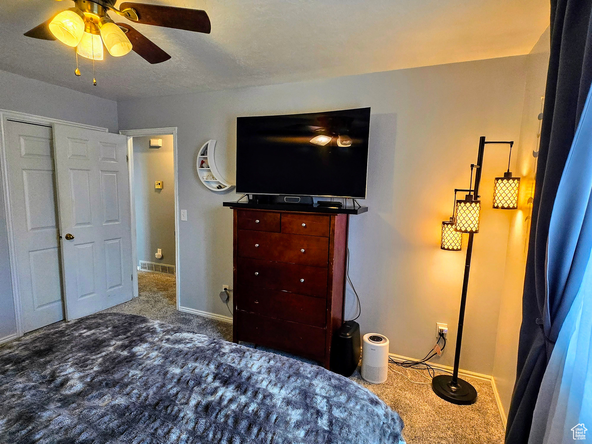 Bedroom featuring ceiling fan and carpet flooring