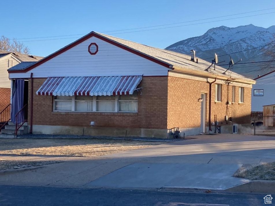 View of property exterior featuring a mountain view
