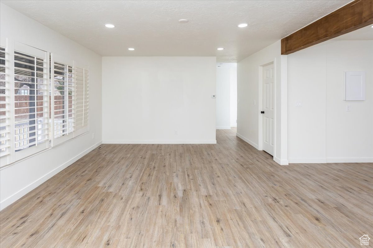 Unfurnished room featuring a textured ceiling and light wood-type flooring