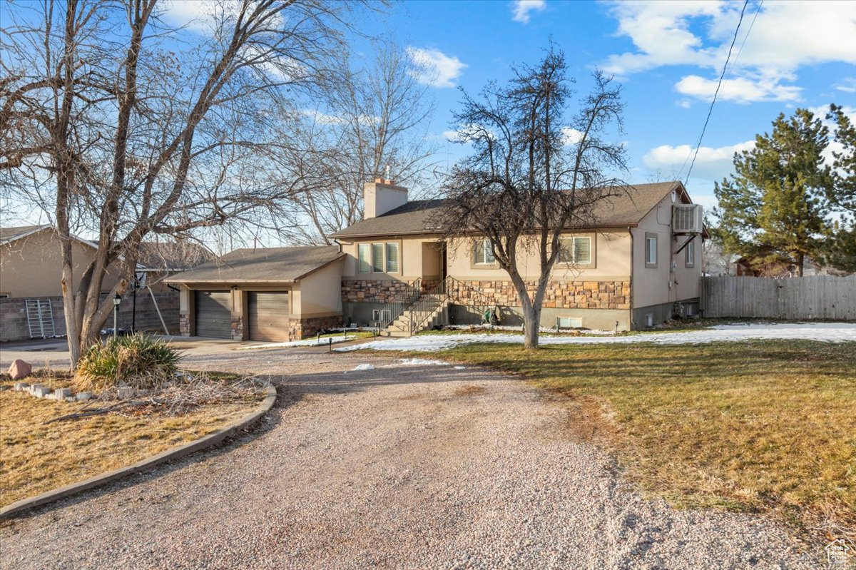 Single story home featuring a garage and a front yard