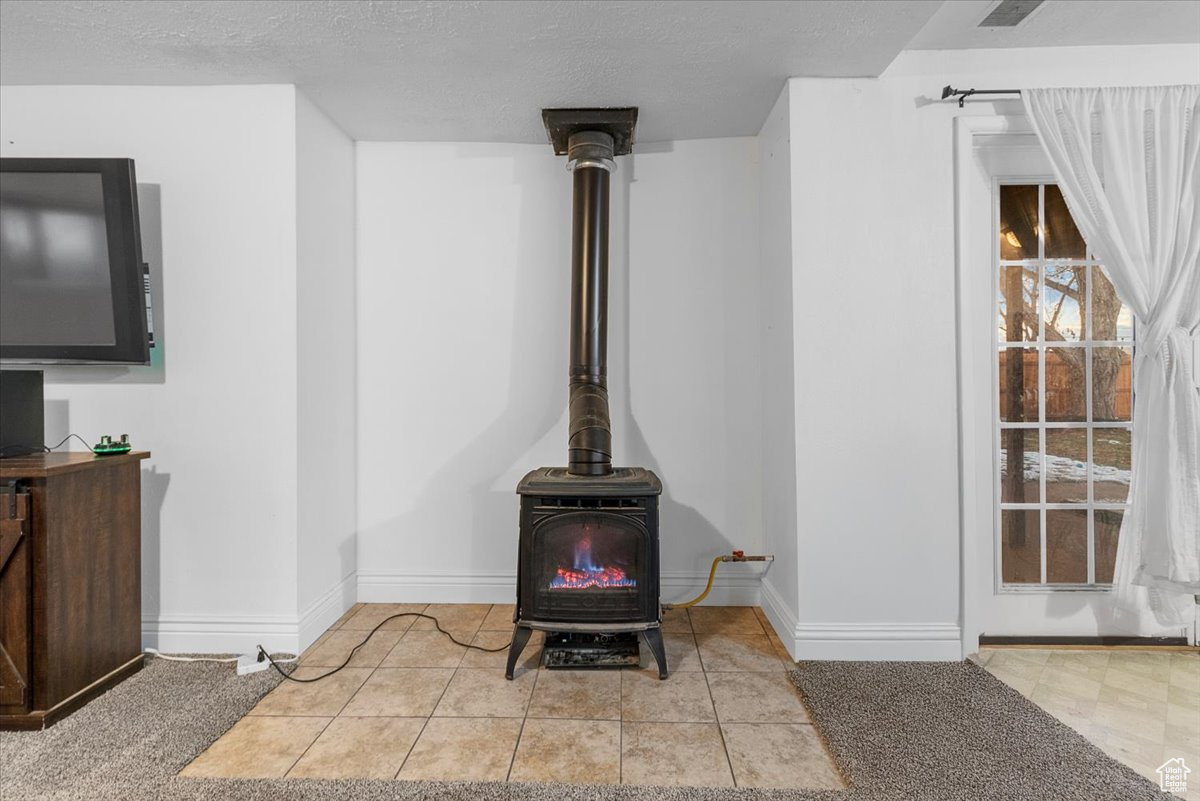 Details featuring a textured ceiling and Natural gas stove.