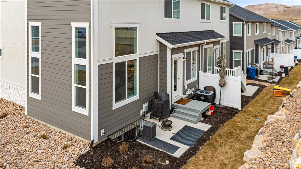 Rear view of property with a mountain view and a patio area