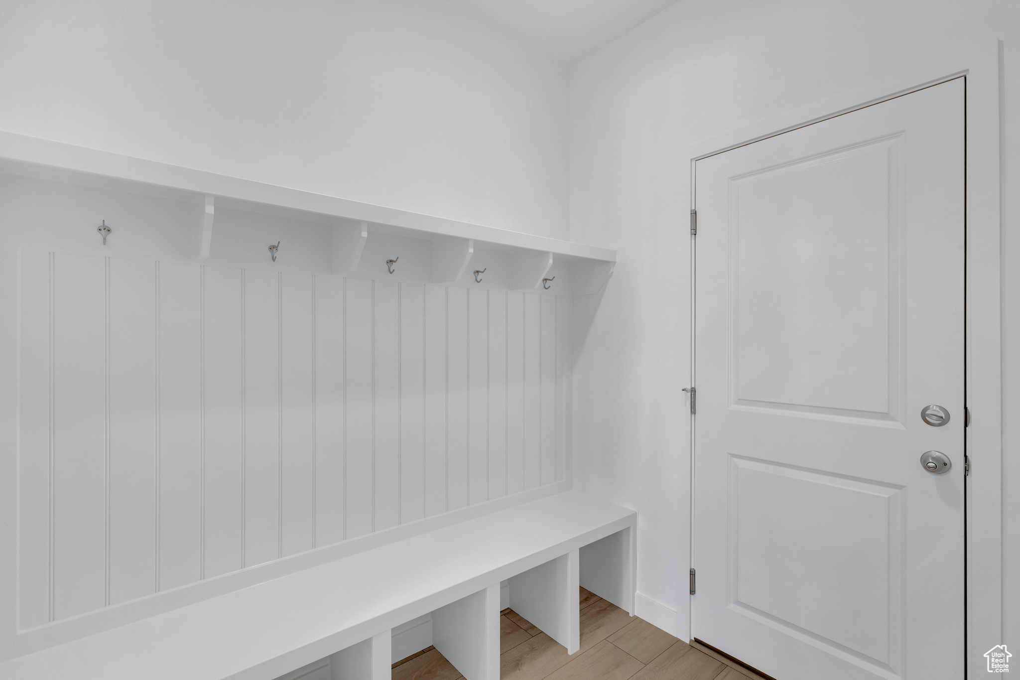 Mudroom with light hardwood / wood-style flooring