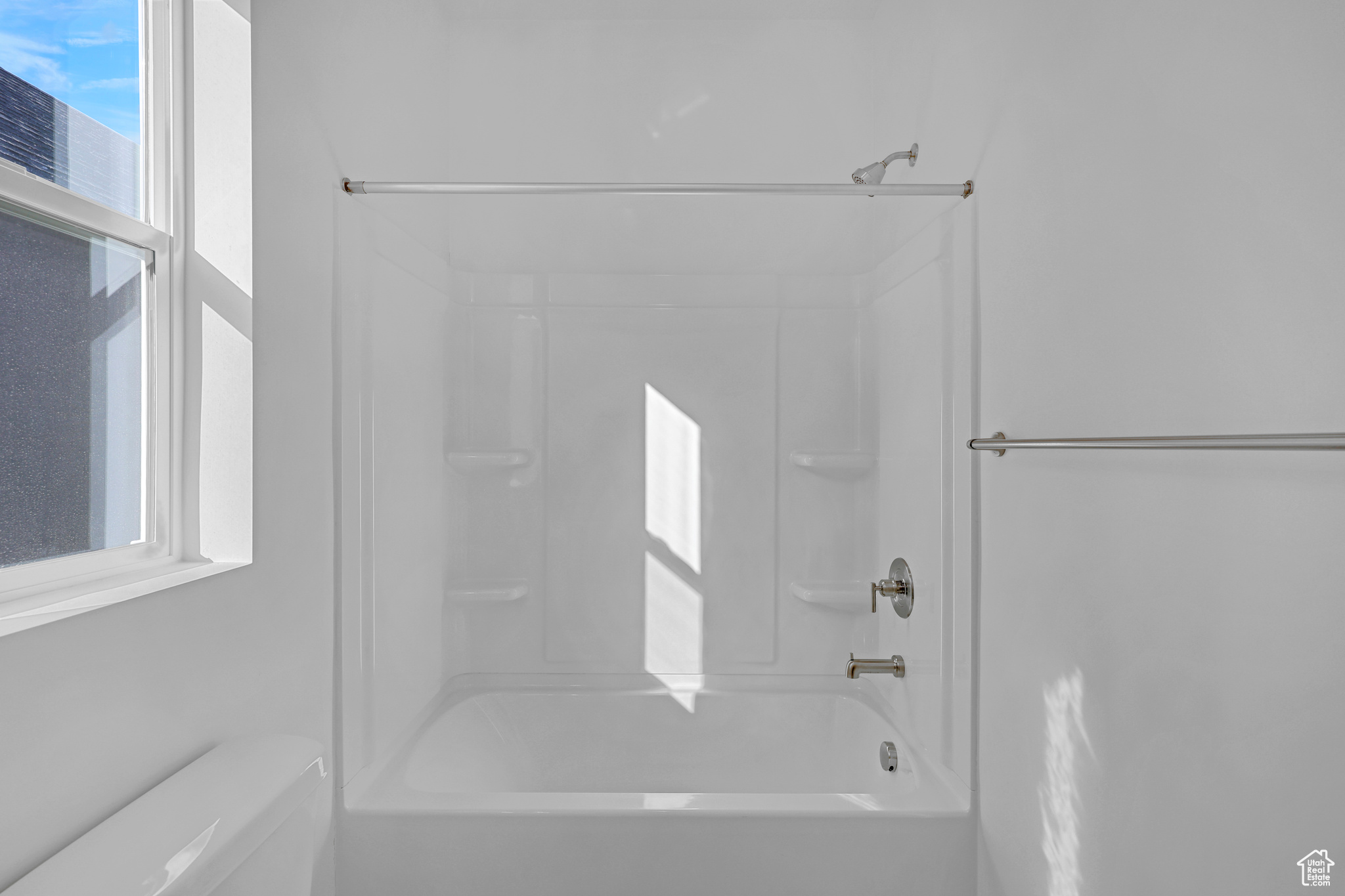Bathroom featuring toilet and bathtub / shower combination