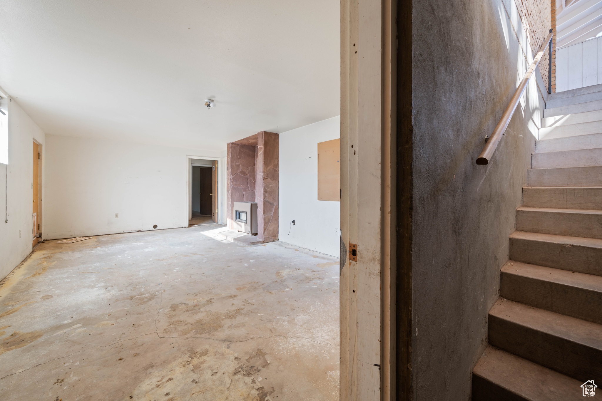 Unfurnished living room featuring heating unit