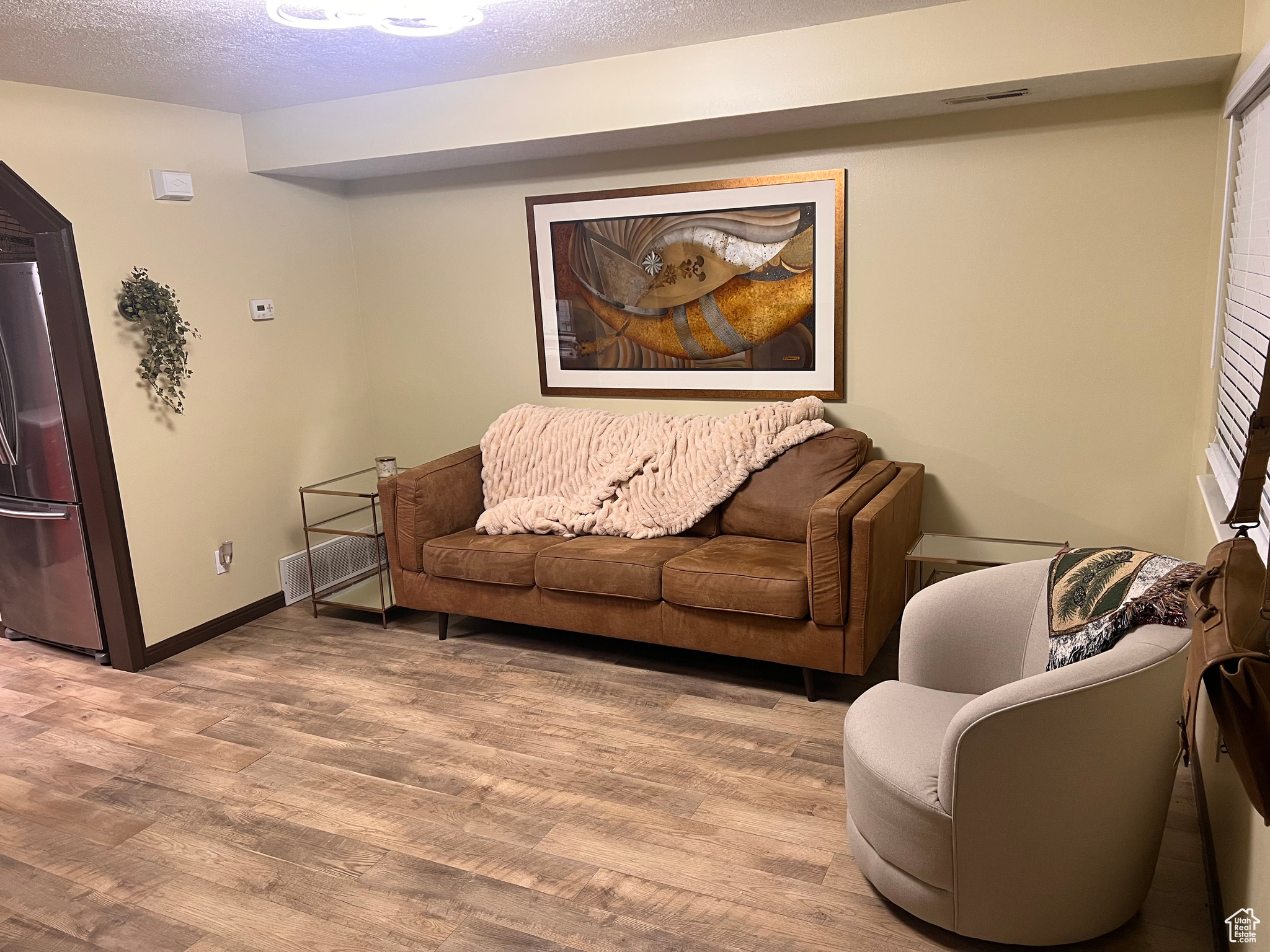 Living room with hardwood / wood-style flooring and a textured ceiling
