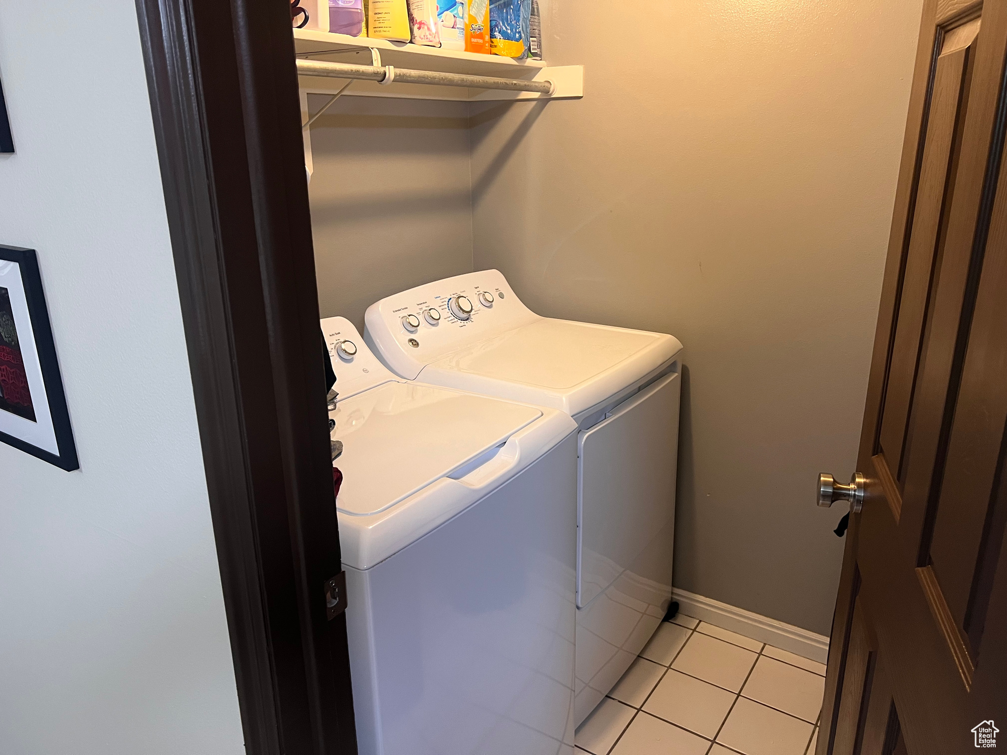 Laundry area featuring separate washer and dryer and light tile patterned floors