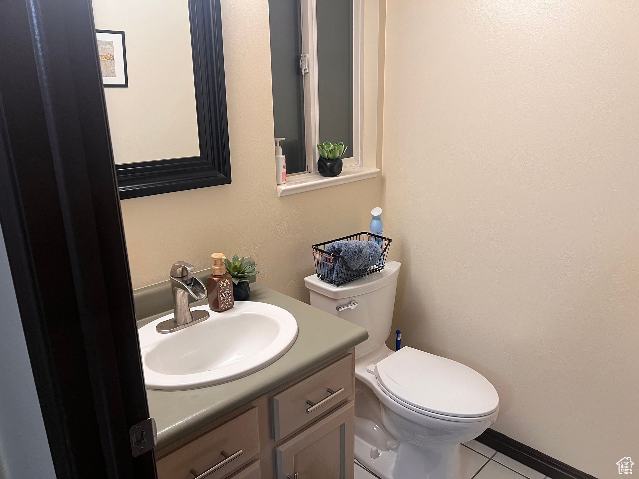 Bathroom with vanity, tile patterned floors, and toilet