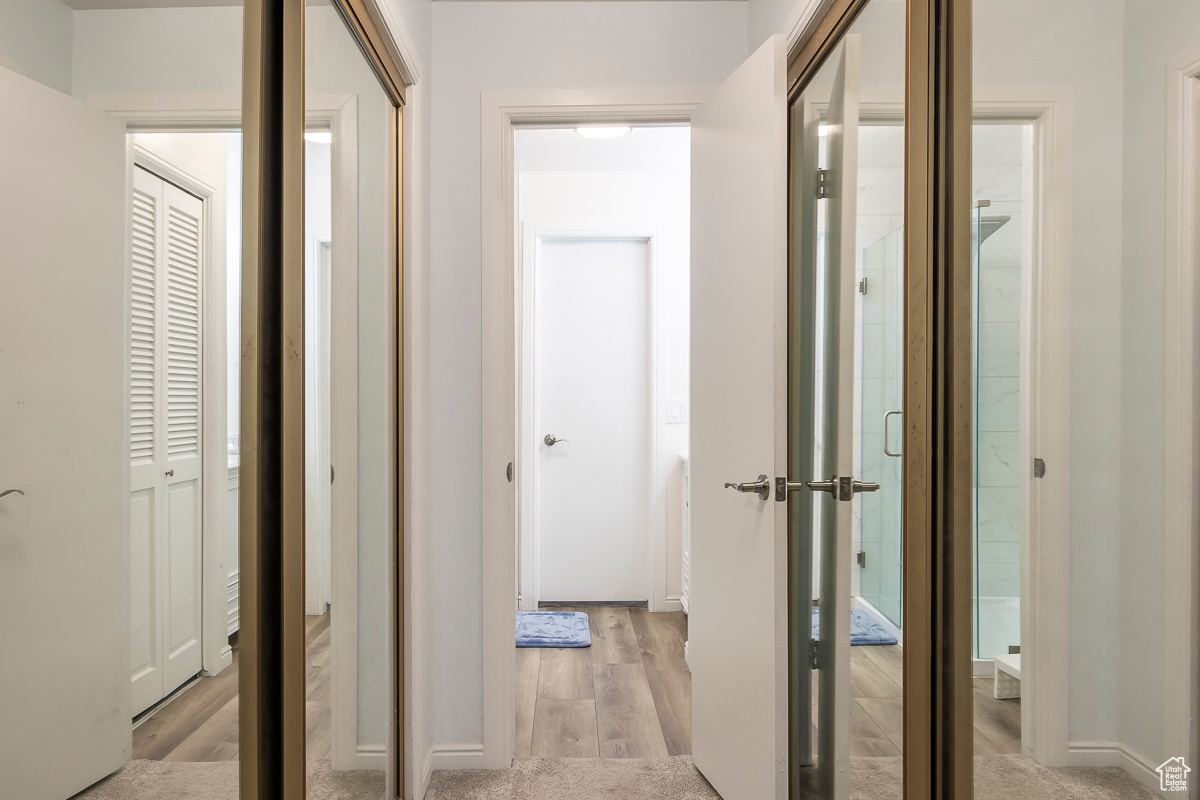Hall with light hardwood / wood-style floors