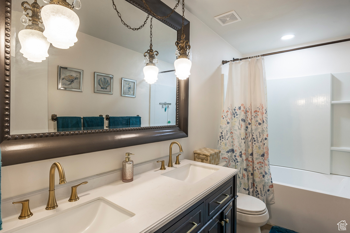 Full bathroom with vanity, toilet, and shower / bath combo