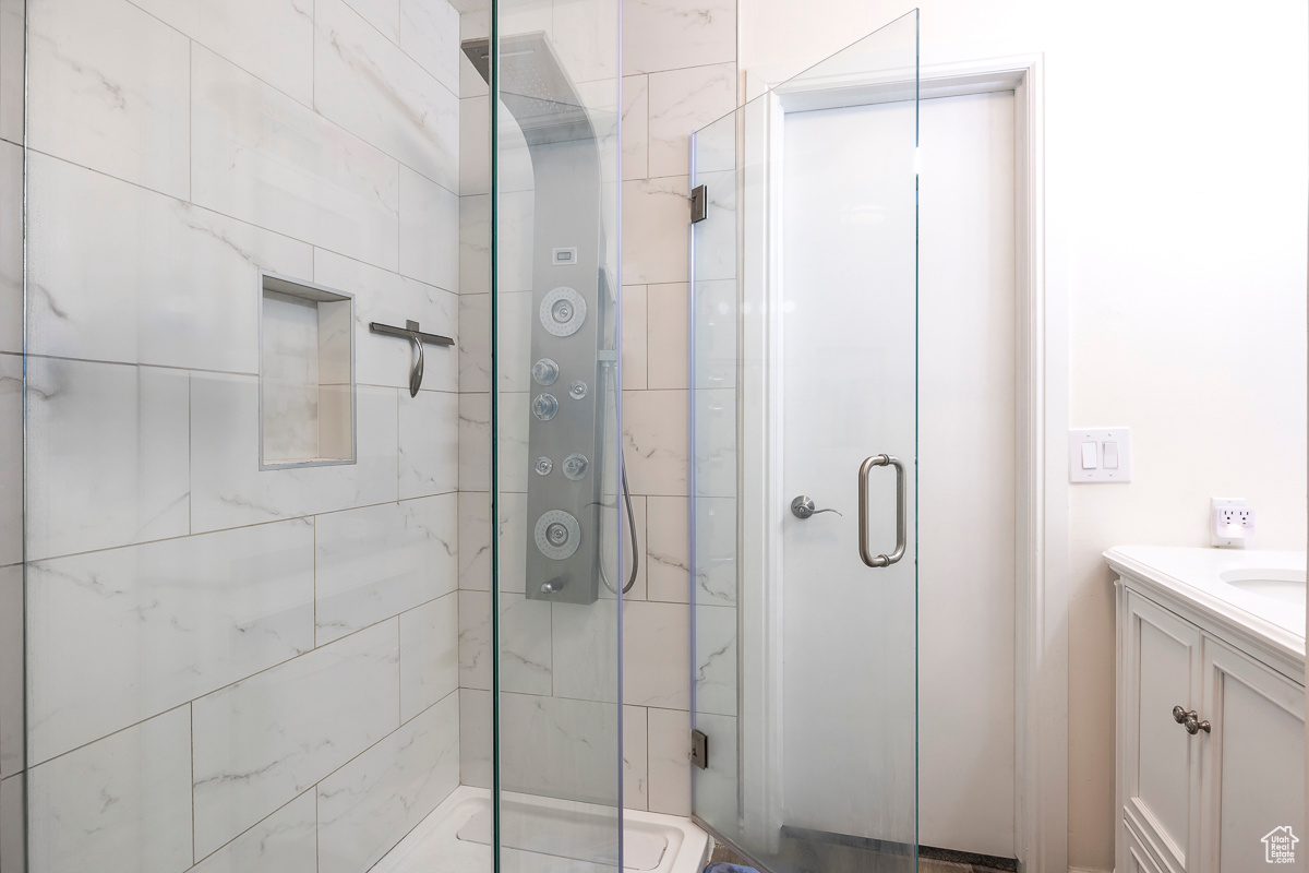 Bathroom with vanity and a shower with door