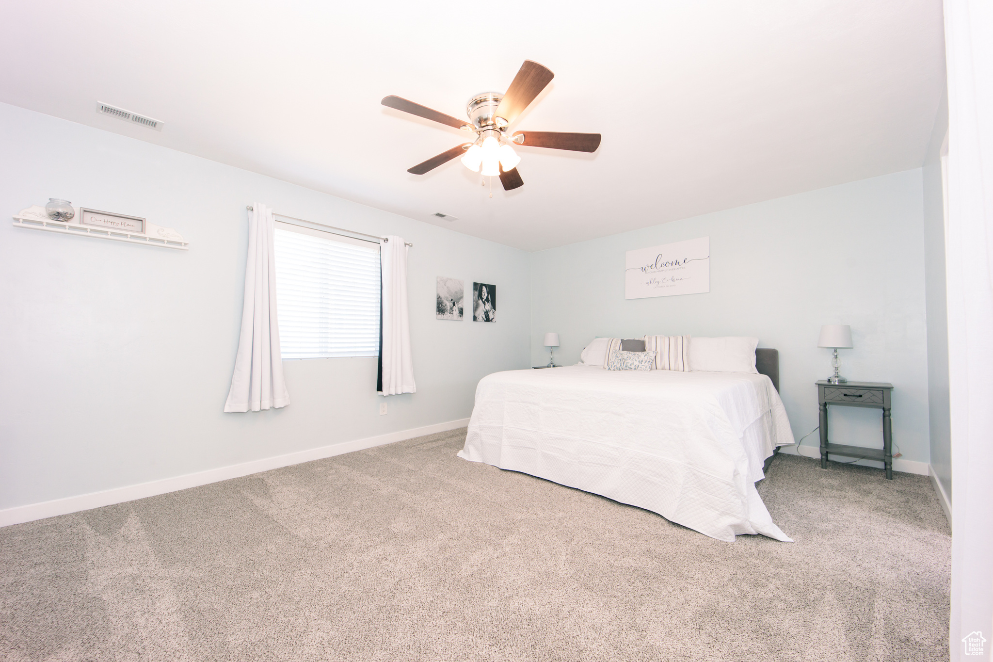 Carpeted bedroom with ceiling fan