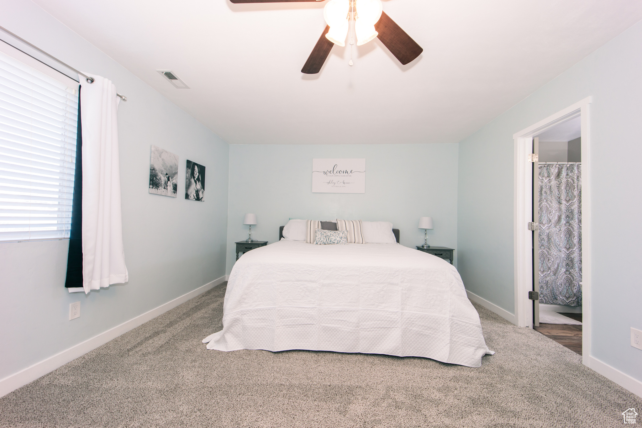 Carpeted bedroom featuring ceiling fan