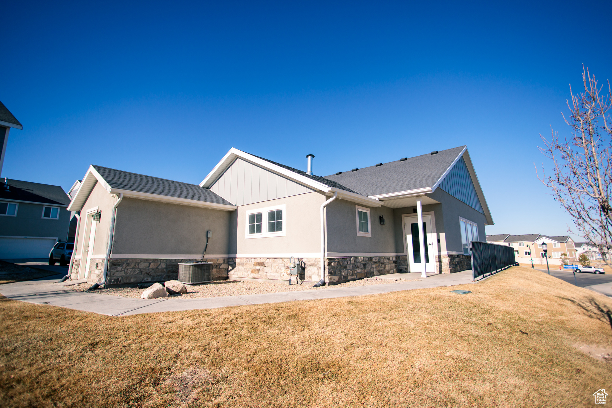 Back of house featuring central AC and a lawn