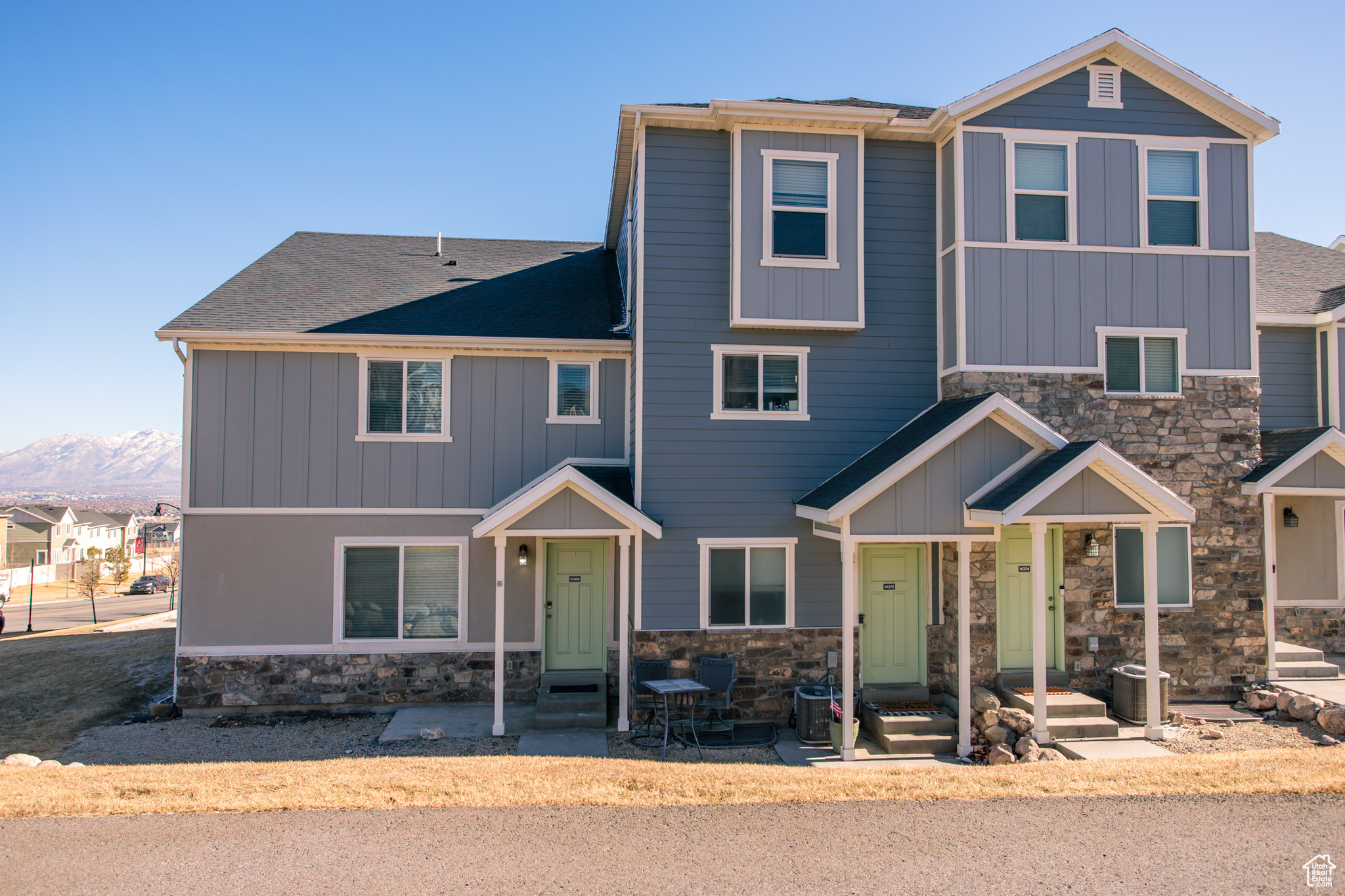 View of front of home featuring a mountain view and cooling unit