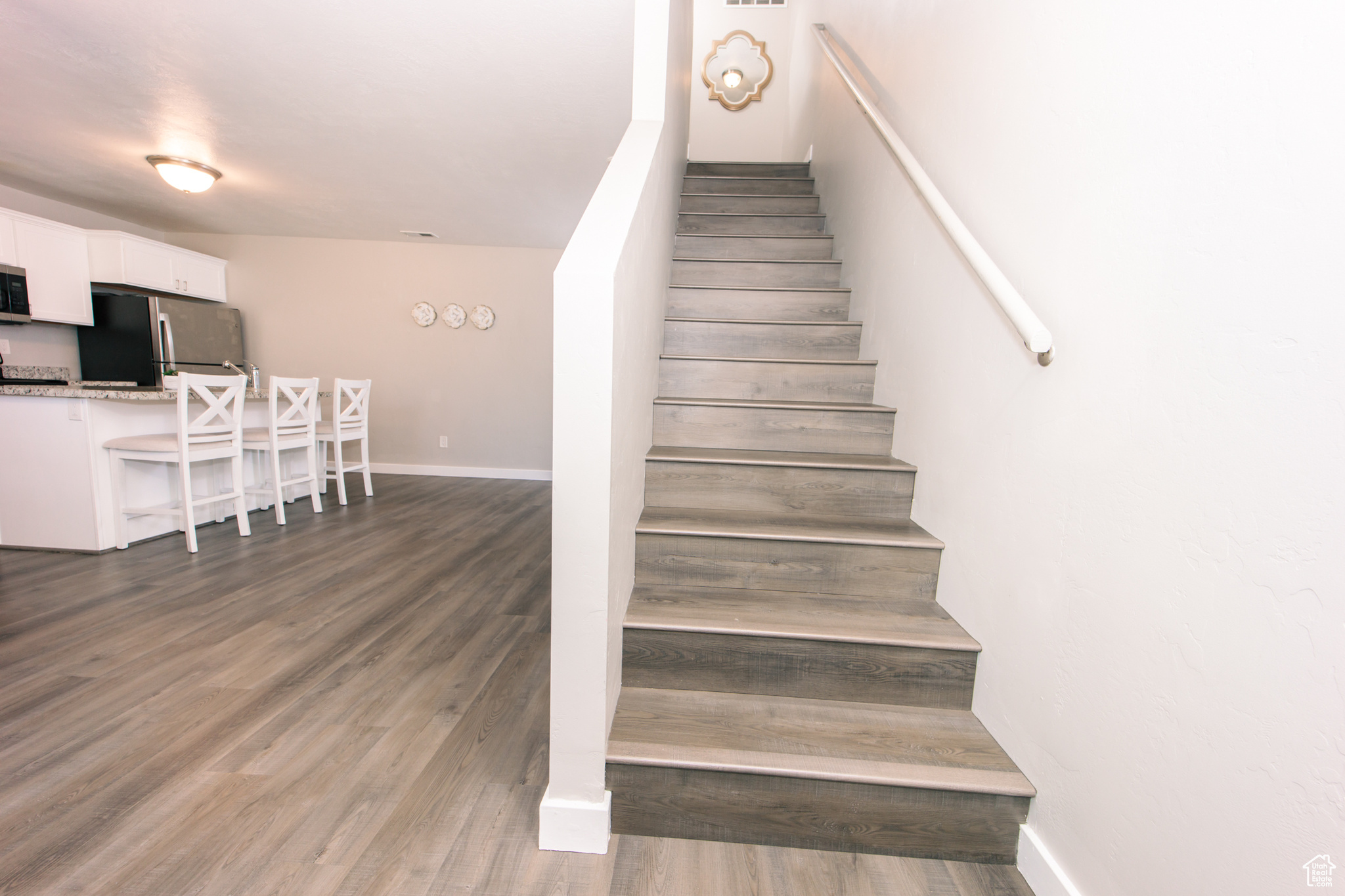 Stairway featuring wood-type flooring