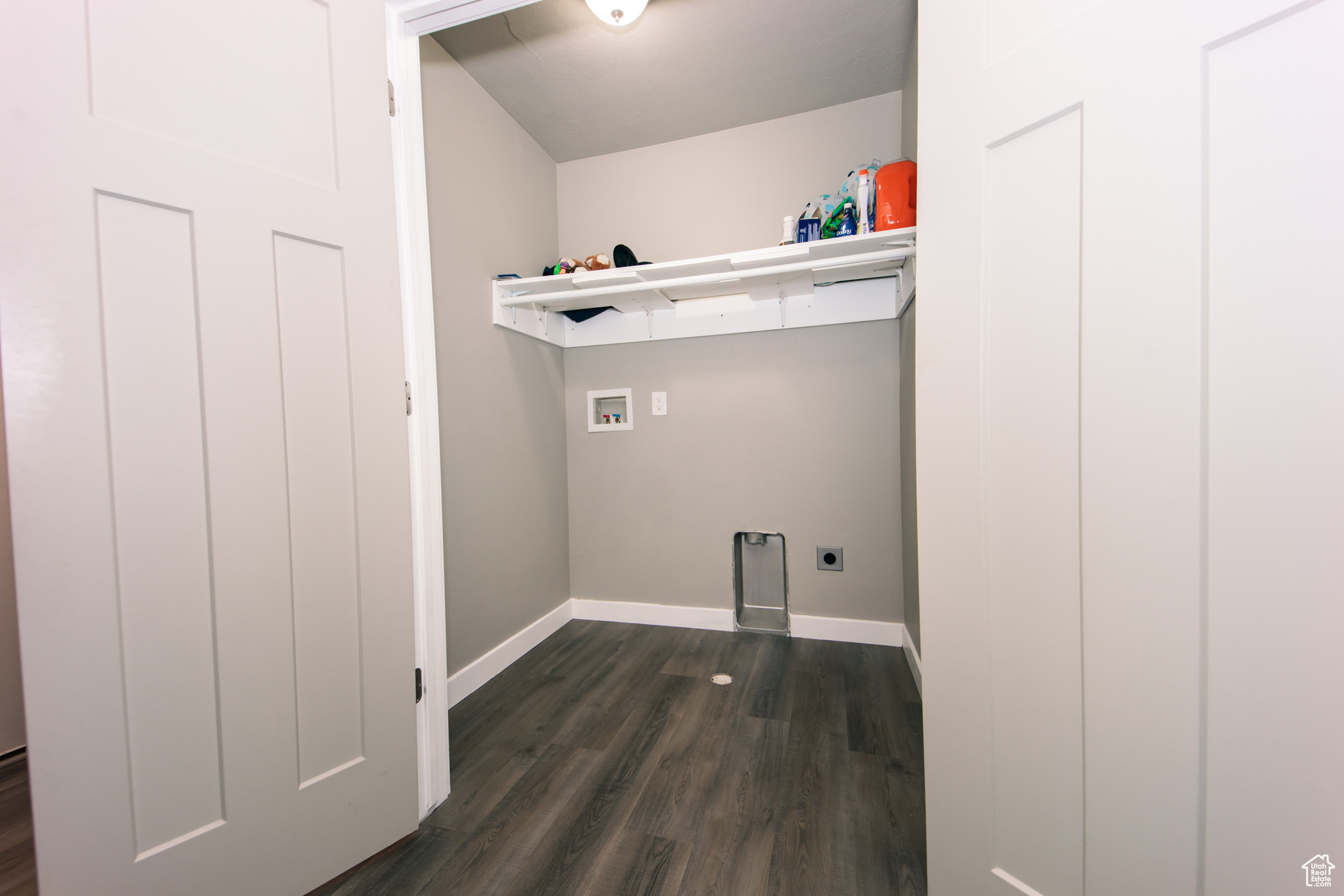 Laundry room featuring electric dryer hookup, washer hookup, and dark hardwood / wood-style floors