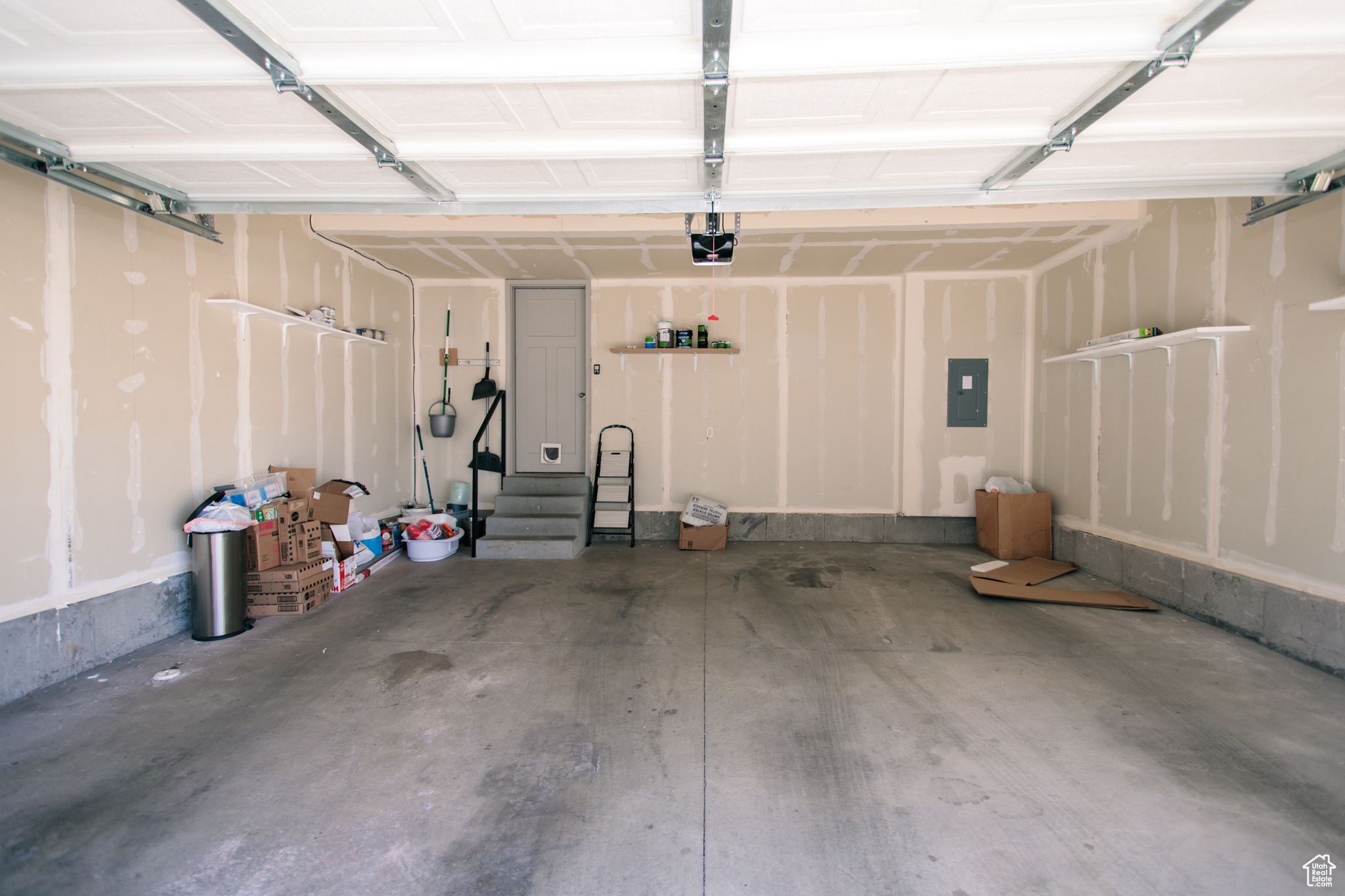 Garage with a garage door opener and electric panel