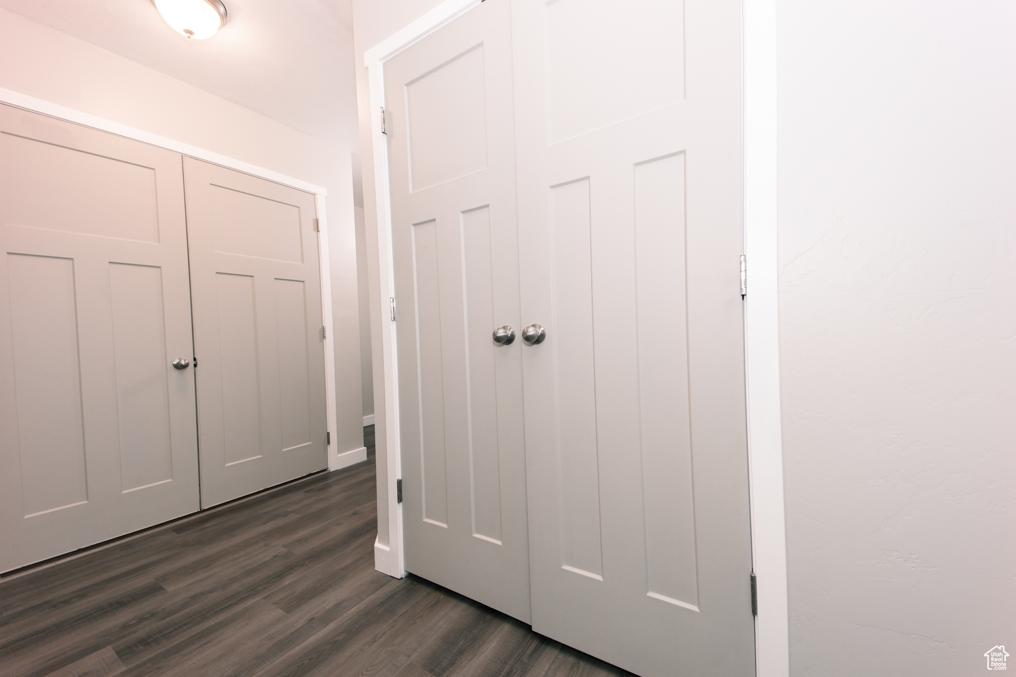 Hall with dark hardwood / wood-style floors