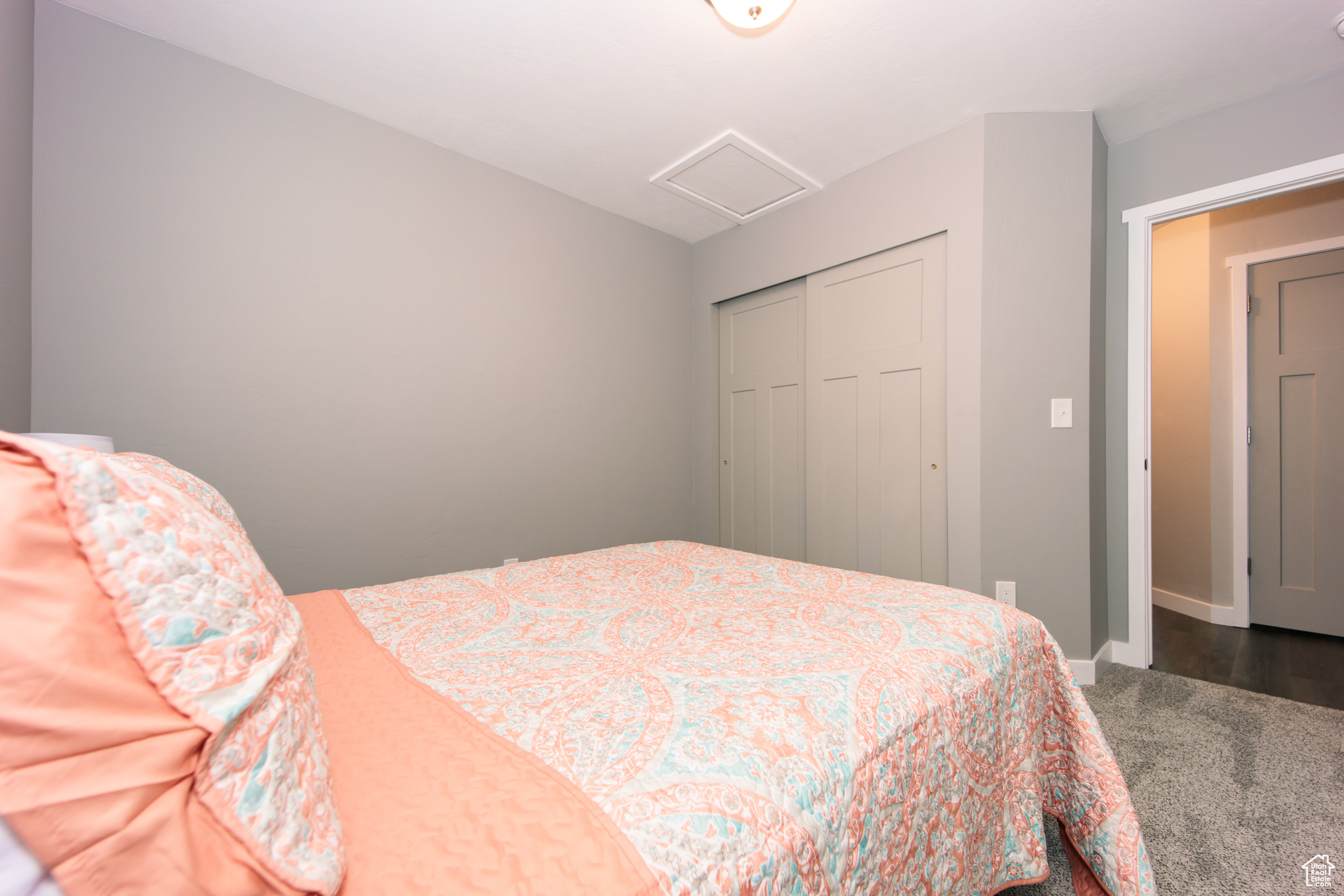 Bedroom with wood-type flooring and a closet