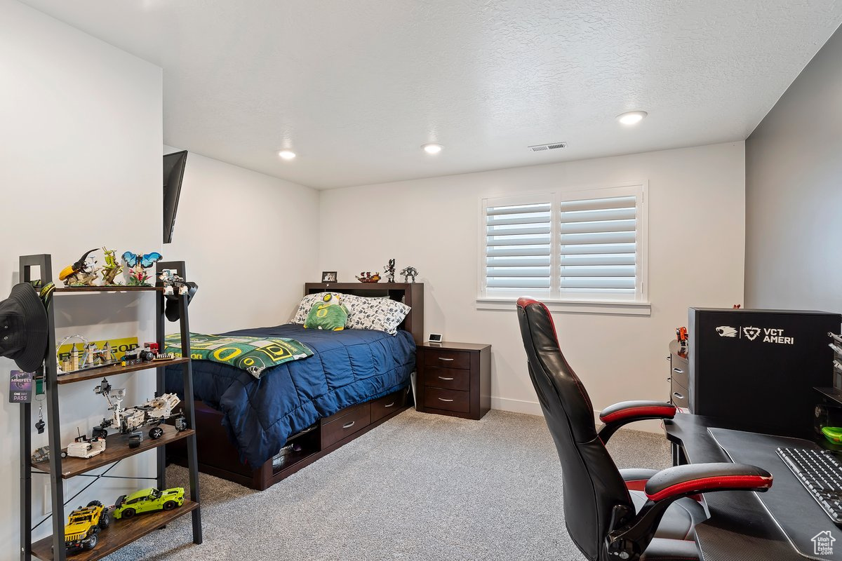 Basement Carpeted bedroom with a textured ceiling