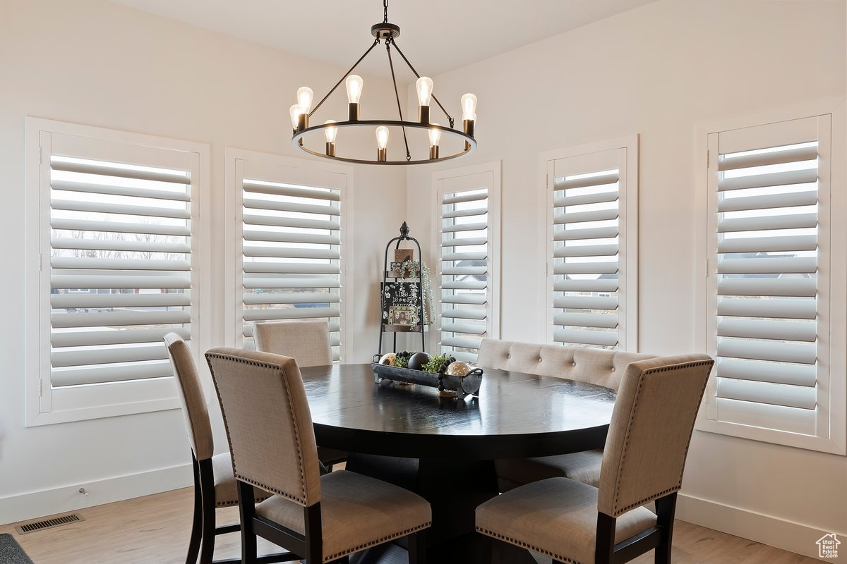 Dining space featuring an inviting chandelier and light hardwood / wood-style flooring