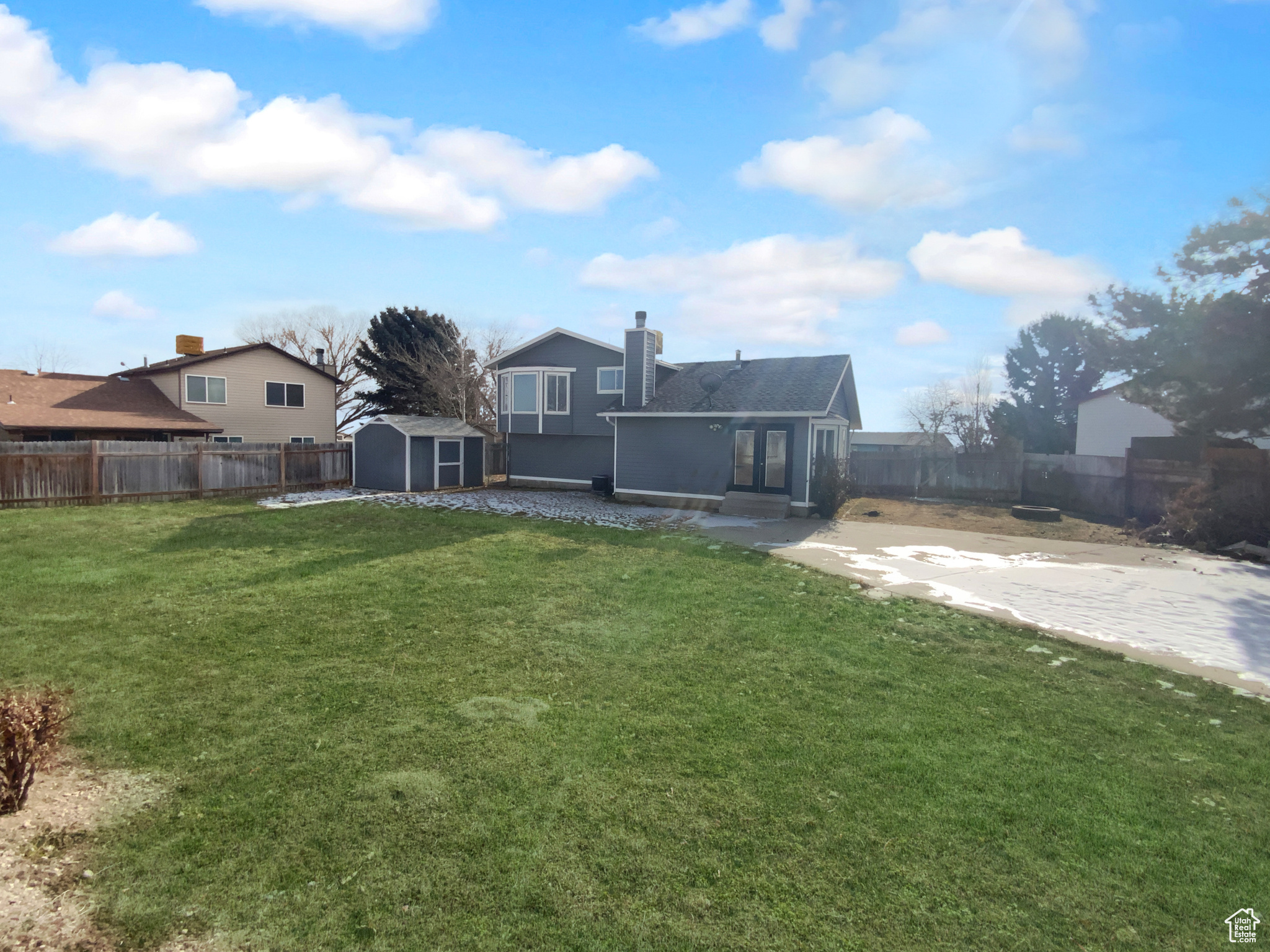 View of yard featuring a storage shed and a patio area
