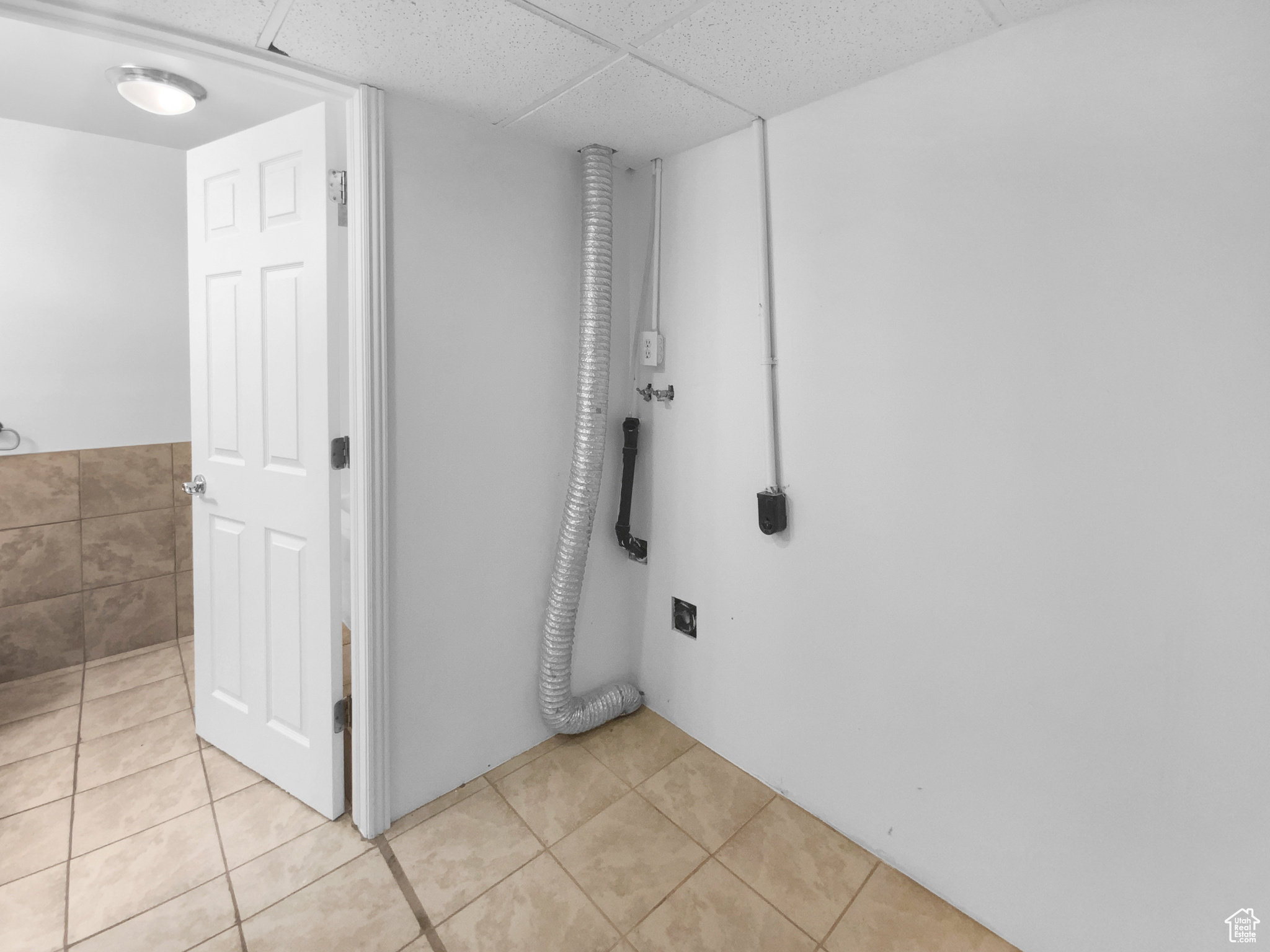 Bathroom featuring tile patterned flooring and a paneled ceiling