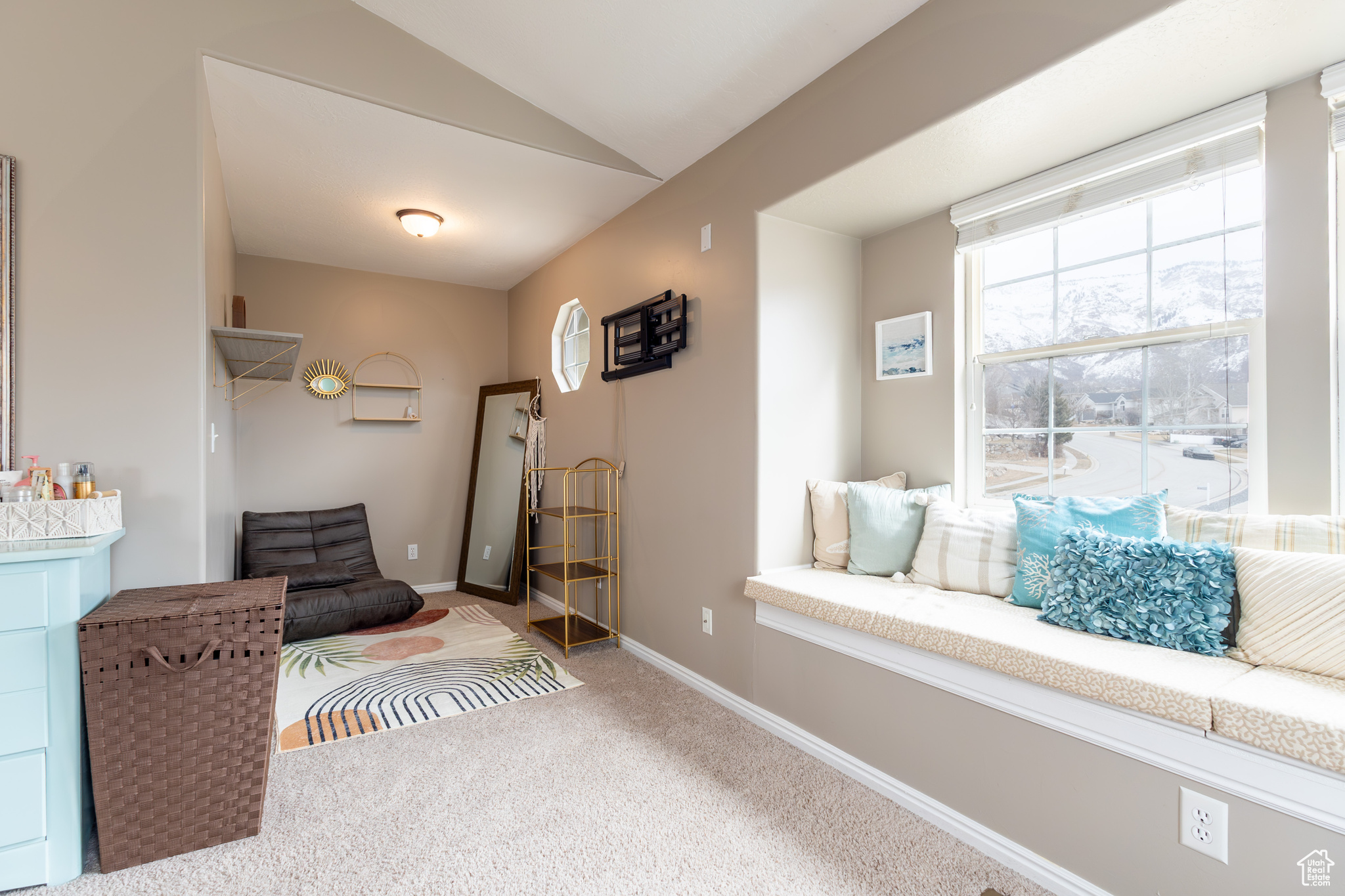 Living area featuring lofted ceiling and carpet flooring