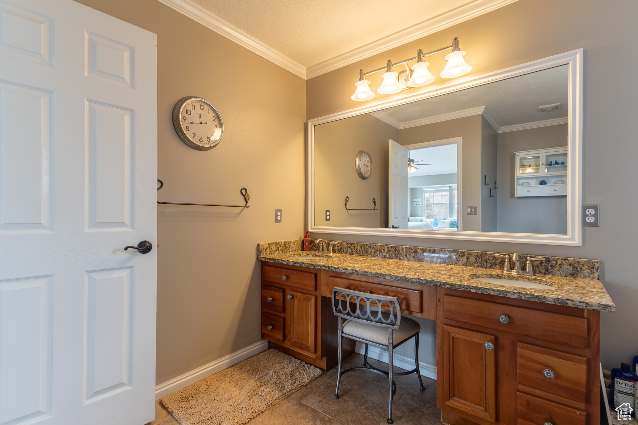 Bathroom featuring vanity, ornamental molding, and tile patterned floors