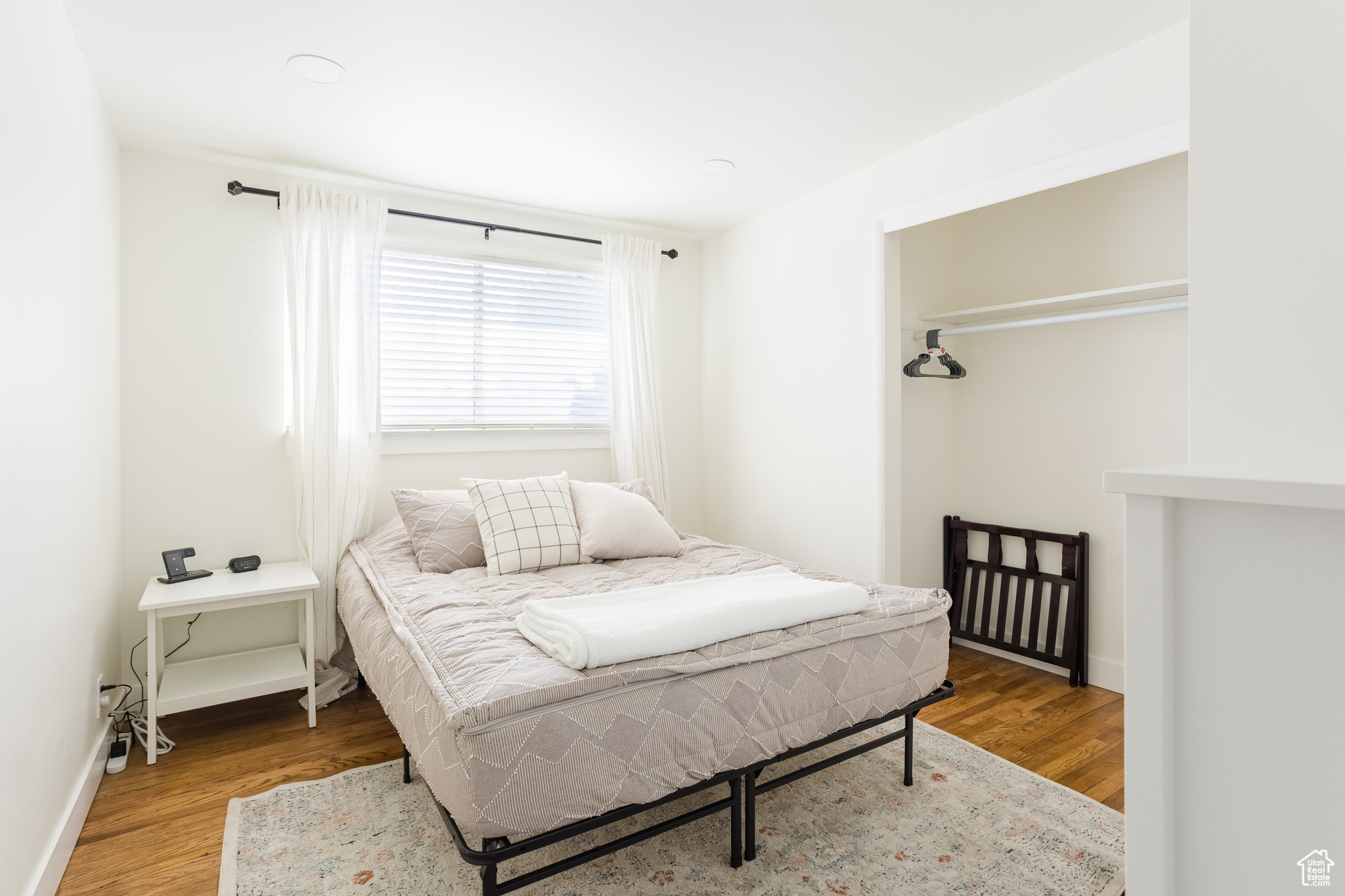 Bedroom with hardwood / wood-style flooring