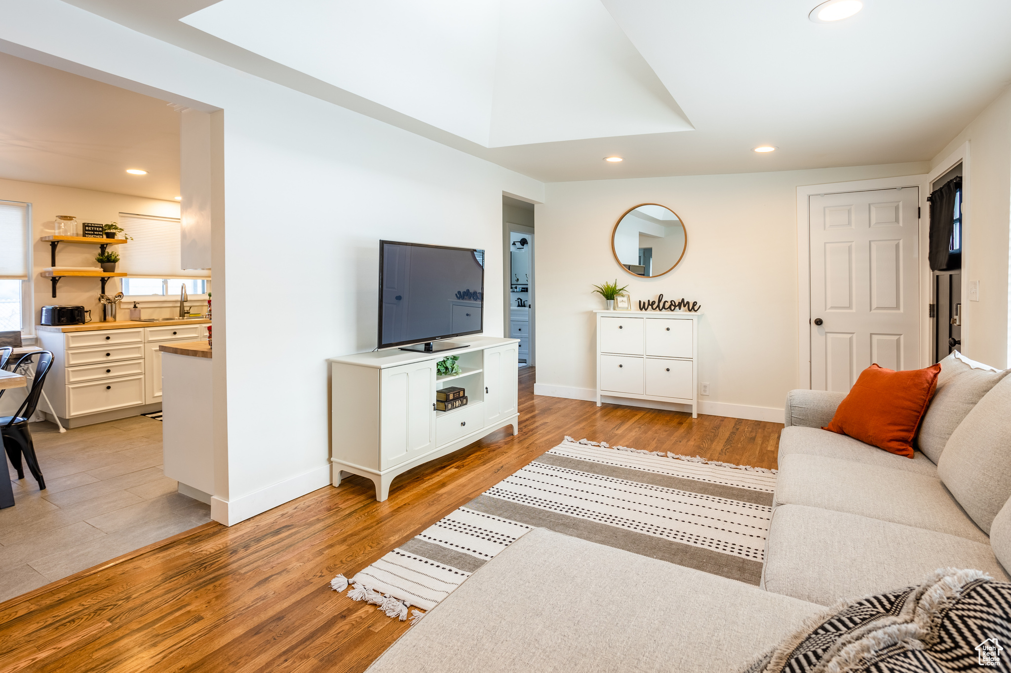 Living room featuring sink and light hardwood / wood-style floors