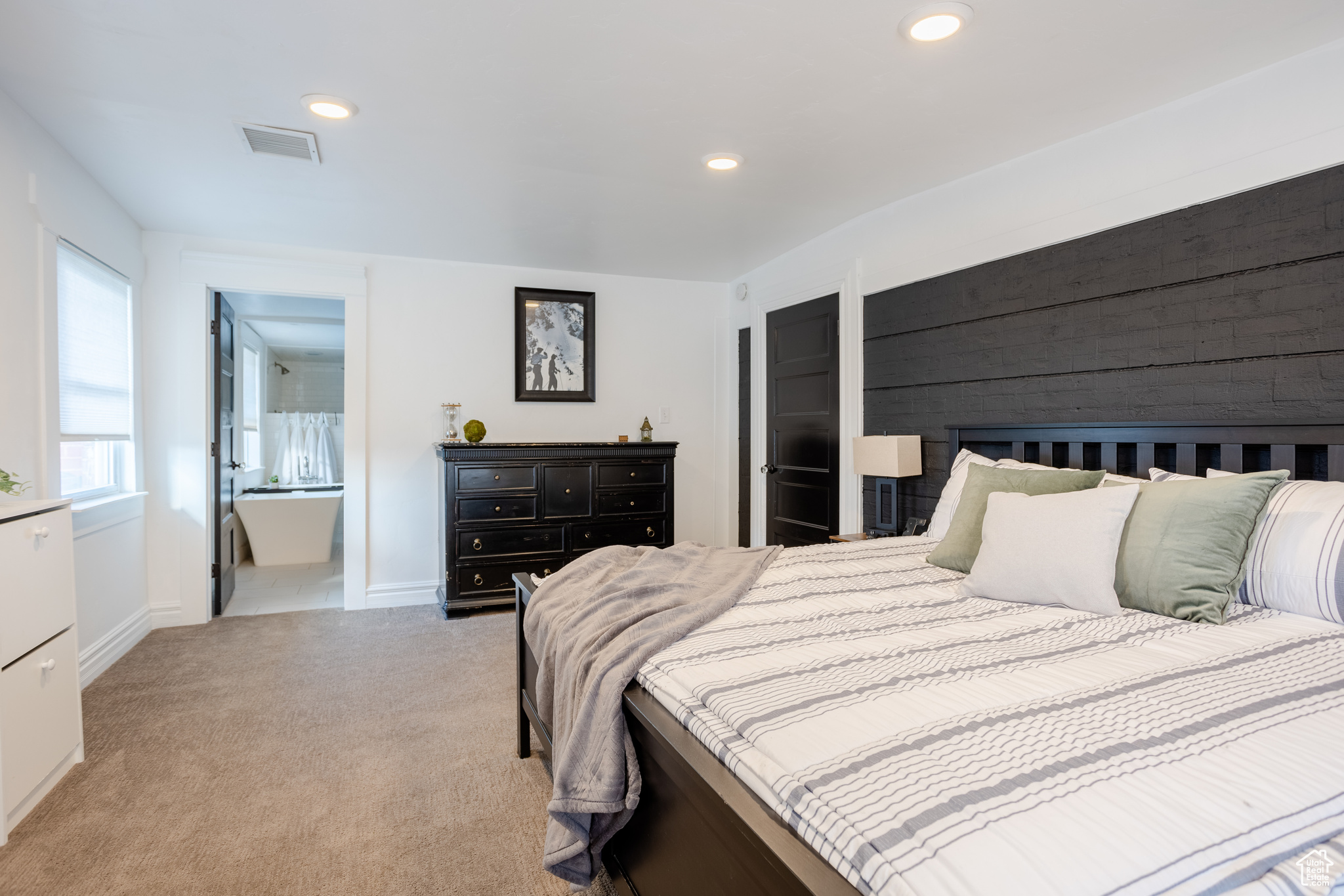 Bedroom with light colored carpet